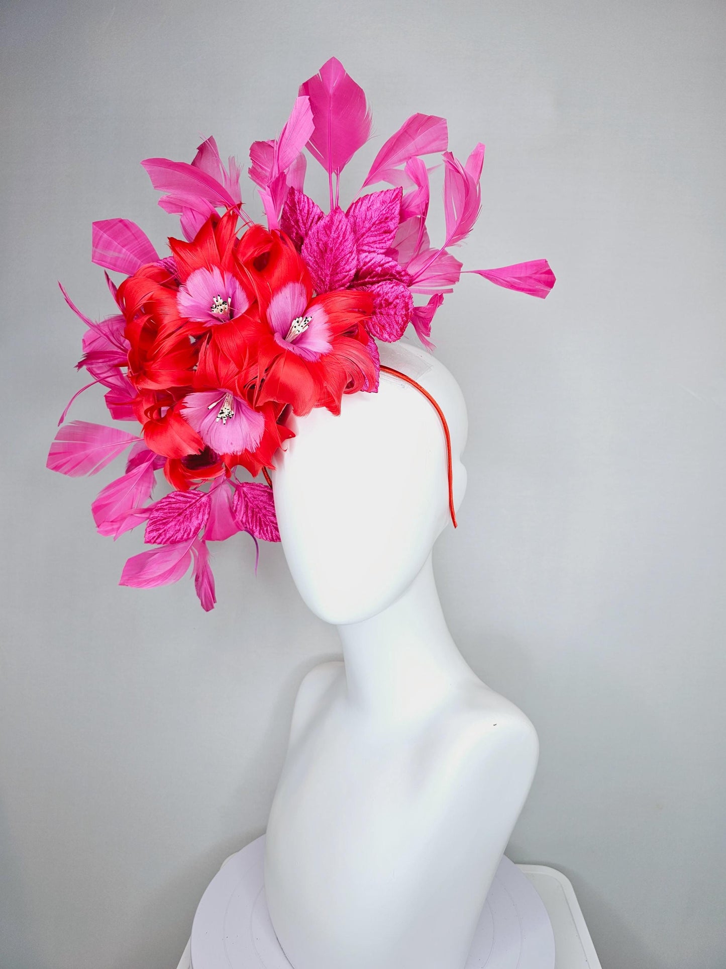 kentucky derby hat fascinator with cherry red feather flowers with blush pink feather cores, pink leaves and pink branching feathers