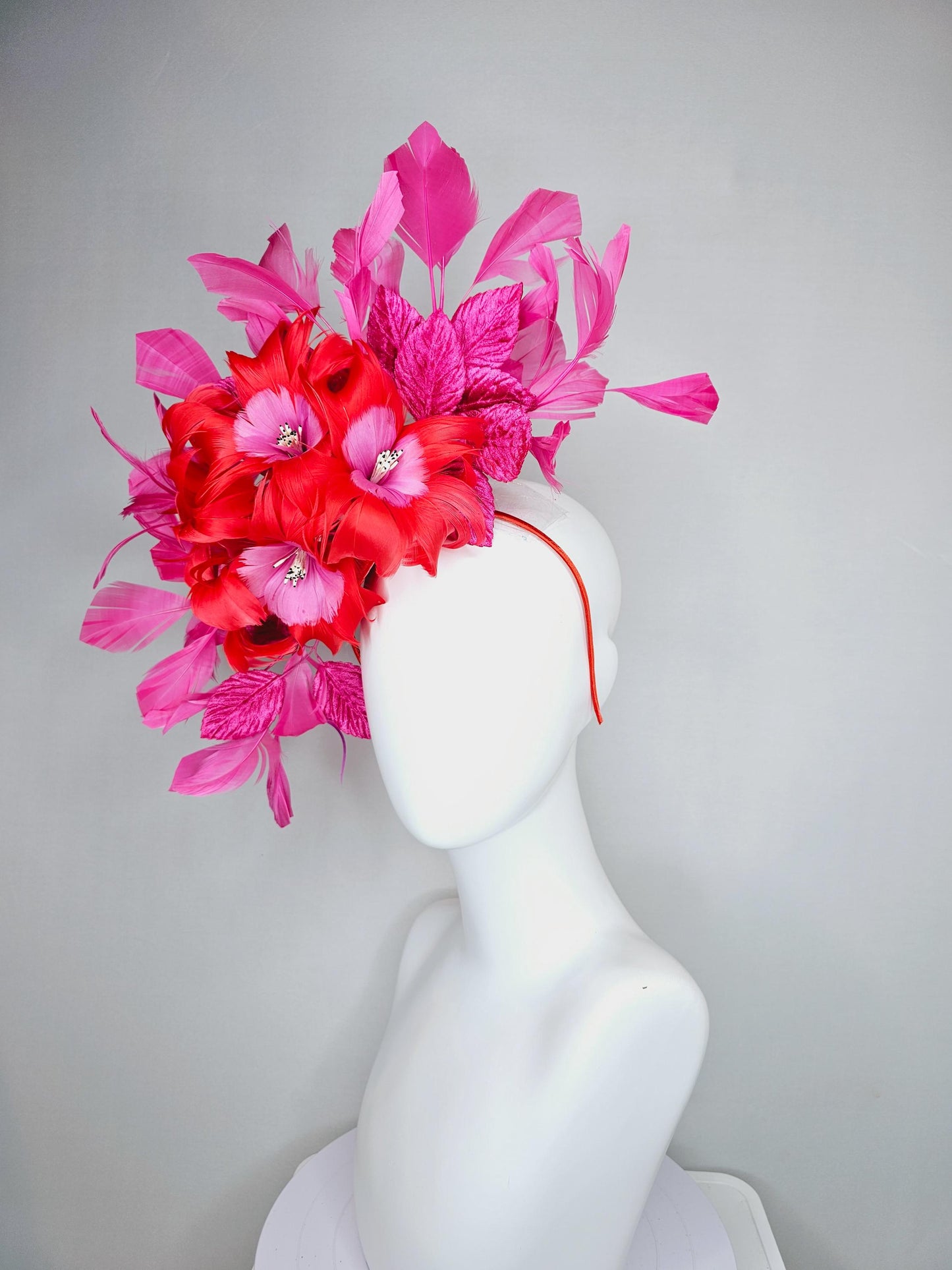 kentucky derby hat fascinator with cherry red feather flowers with blush pink feather cores, pink leaves and pink branching feathers