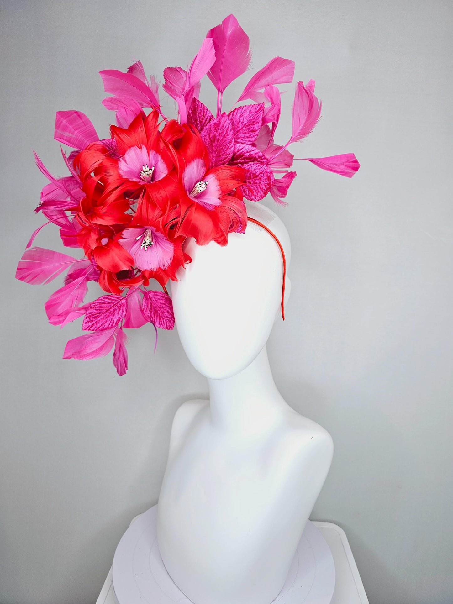 kentucky derby hat fascinator with cherry red feather flowers with blush pink feather cores, pink leaves and pink branching feathers