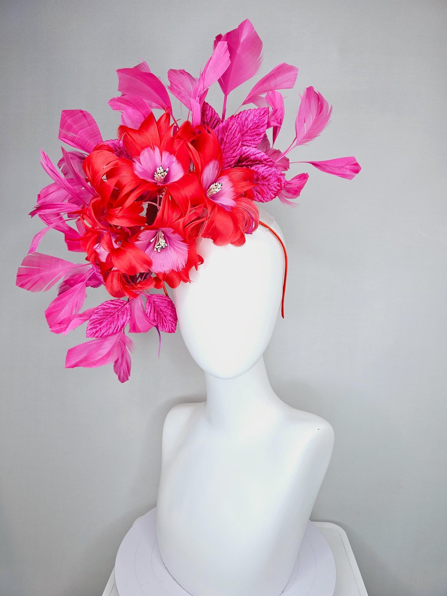 kentucky derby hat fascinator with cherry red feather flowers with blush pink feather cores, pink leaves and pink branching feathers