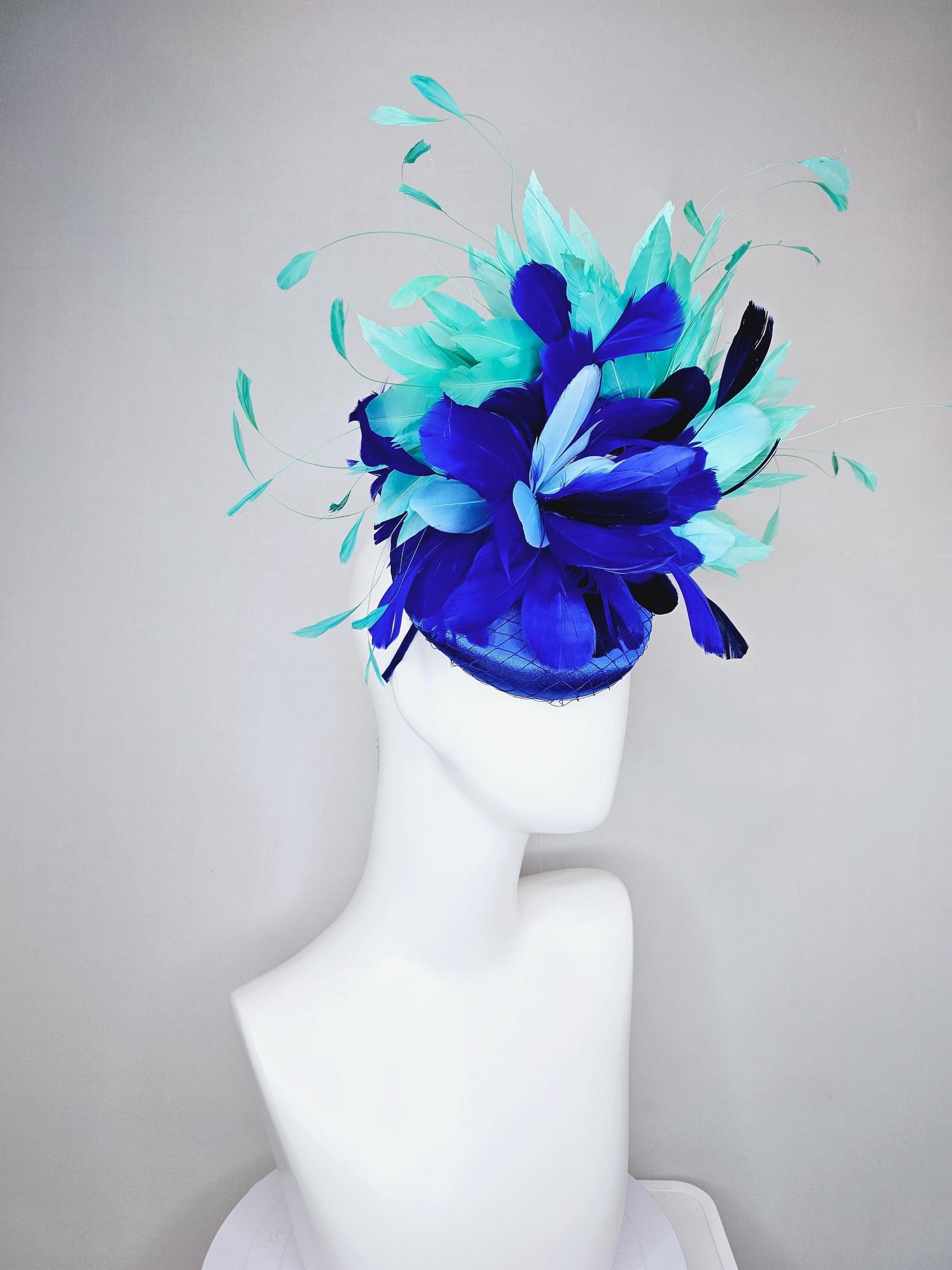 kentucky derby hat fascinator cobalt blue satin with netting and fluffy cobalt blue, light blue,navy blue,aqua blue green branching feathers