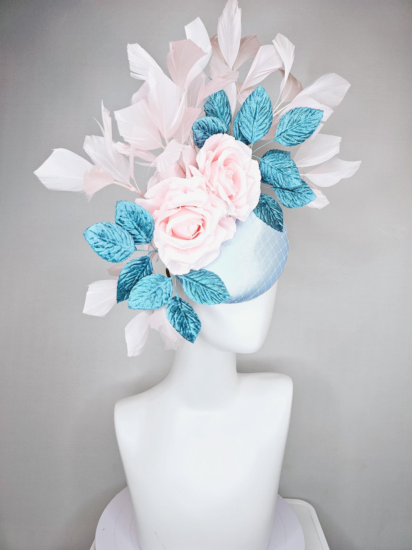 kentucky derby hat fascinator light blue satin with netting, light pink satin rose flowers, blue leaves, light pink branching feathers