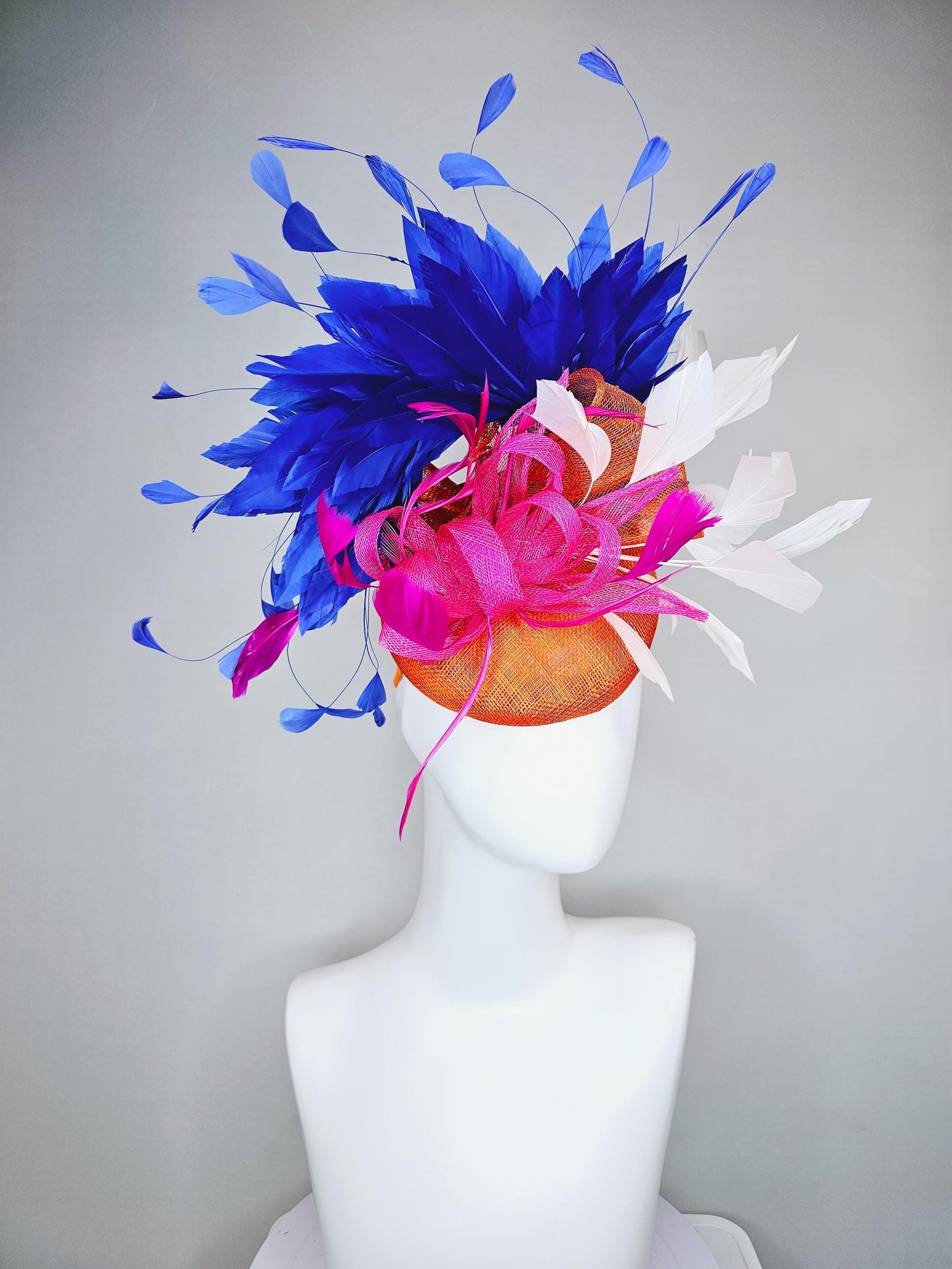 kentucky derby hat fascinator orange sinamay with pink and orange sinamay bow and pink feathers, white and royal blue branching feathers