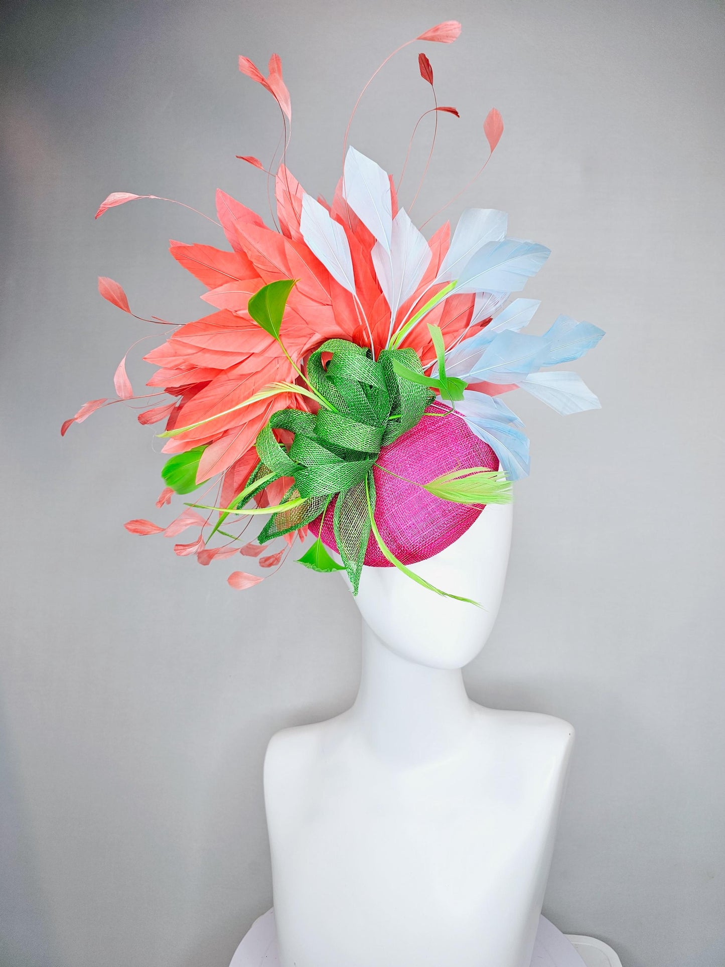 kentucky derby hat fascinator pink sinamay with green sinamay bow and lime green feathers, light blue and coral orange branching feathers