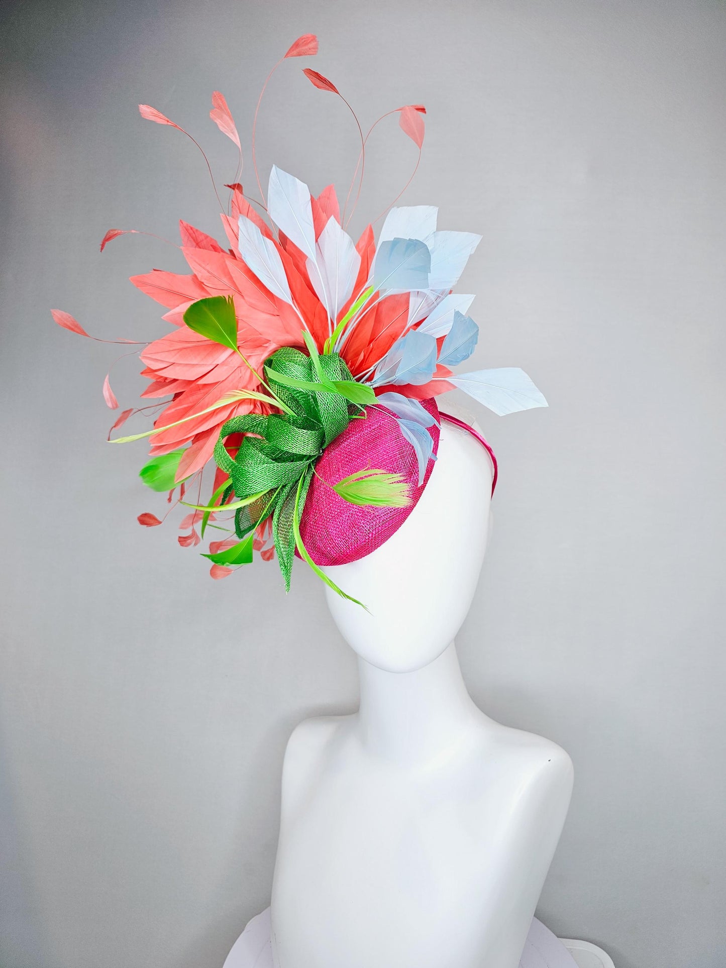 kentucky derby hat fascinator pink sinamay with green sinamay bow and lime green feathers, light blue and coral orange branching feathers