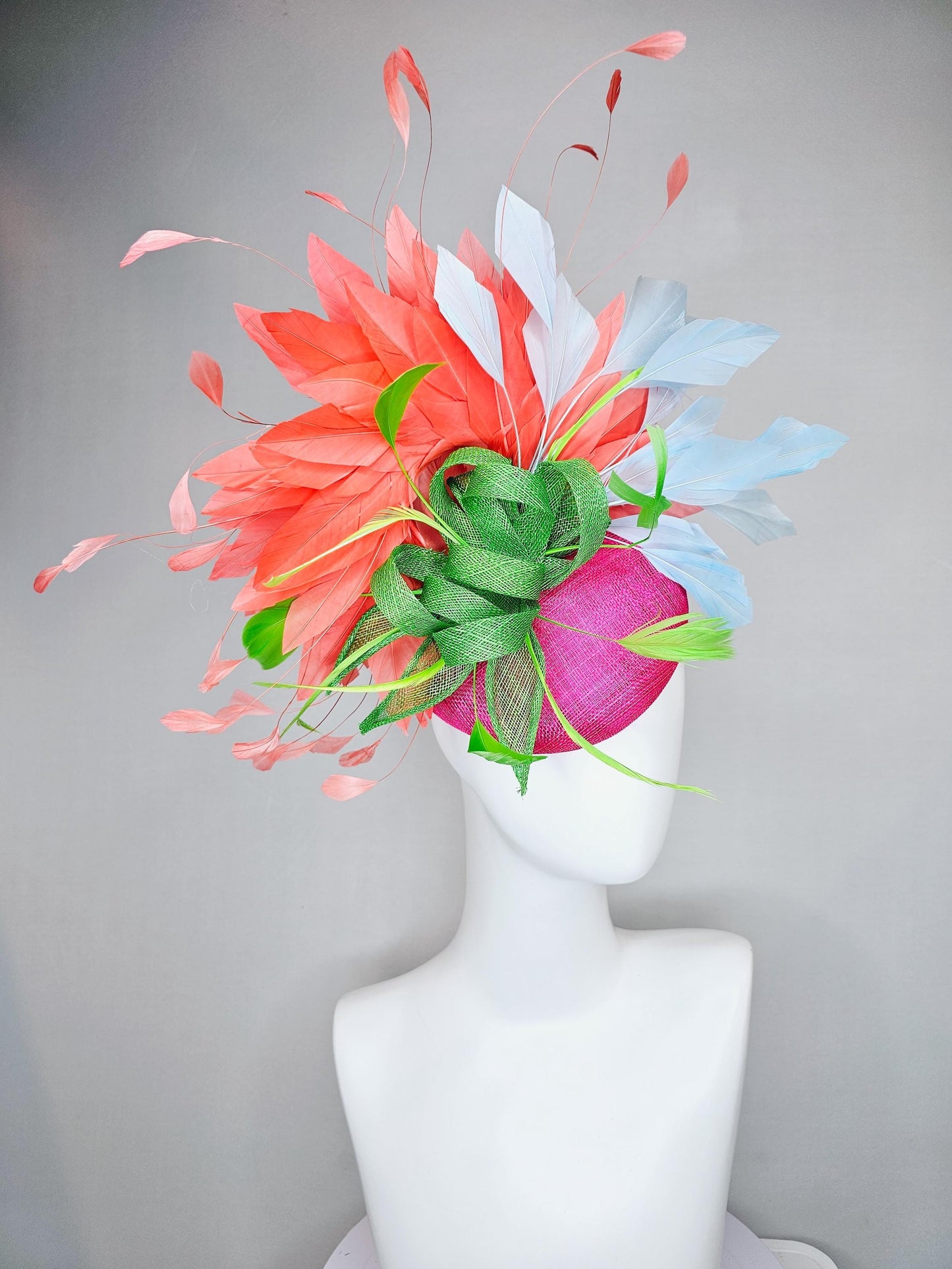 kentucky derby hat fascinator pink sinamay with green sinamay bow and lime green feathers, light blue and coral orange branching feathers