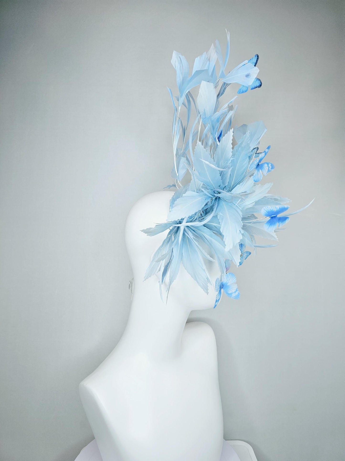 kentucky derby hat fascinator with fluffy light baby blue zigzag feathers, light baby blue branching feathers, light sky blue butterflies