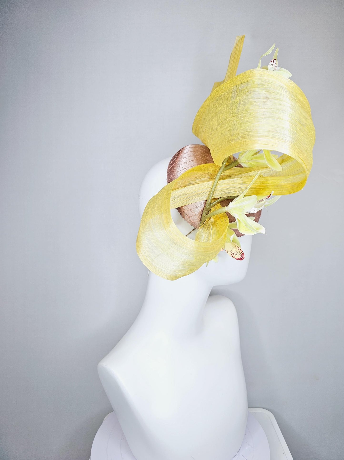 kentucky derby hat fascinator light pink satin with netting, yellow and wine red orchid flowers, yellow silk ribbon large bendable decor