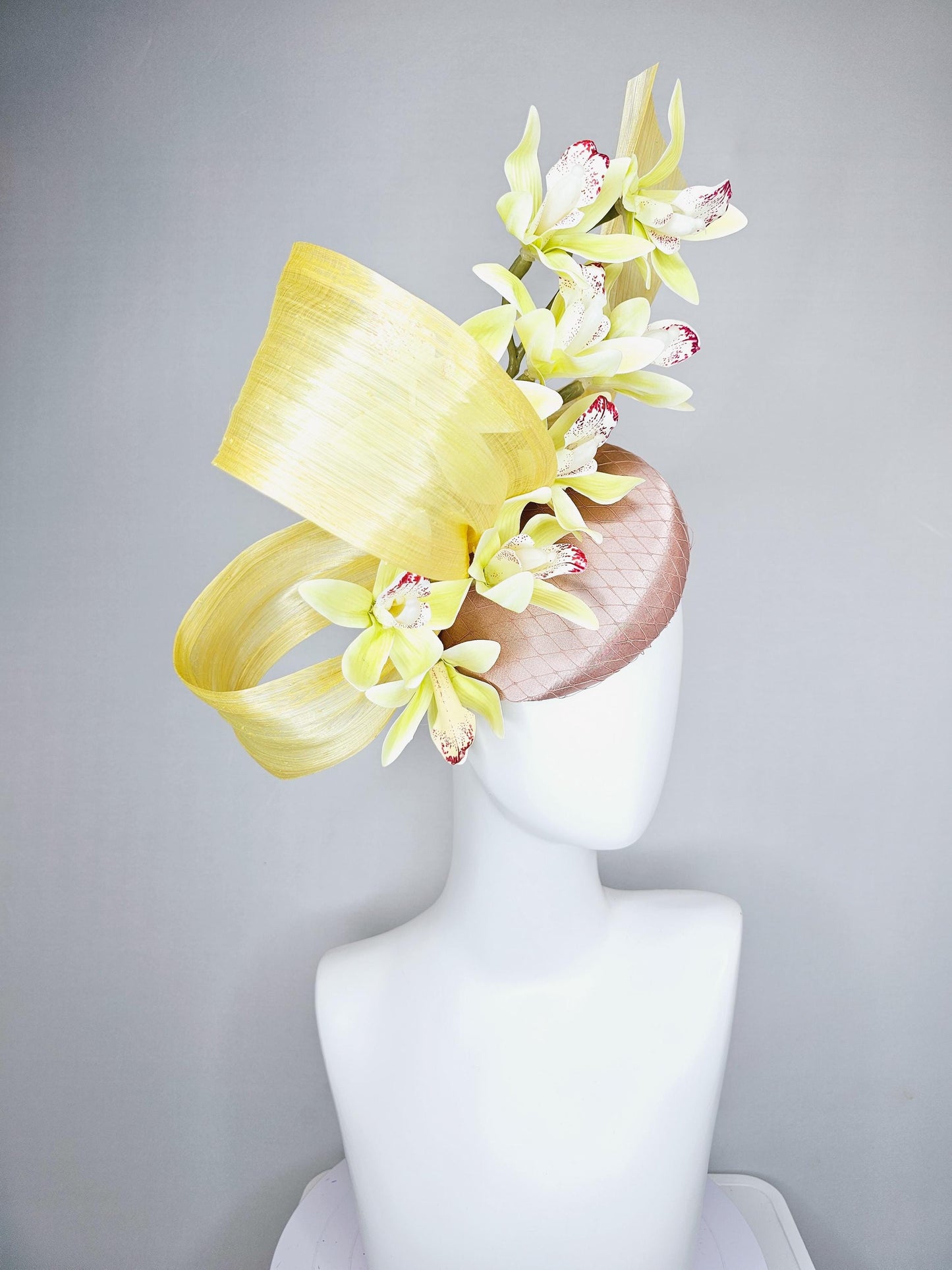 kentucky derby hat fascinator light pink satin with netting, yellow and wine red orchid flowers, yellow silk ribbon large bendable decor