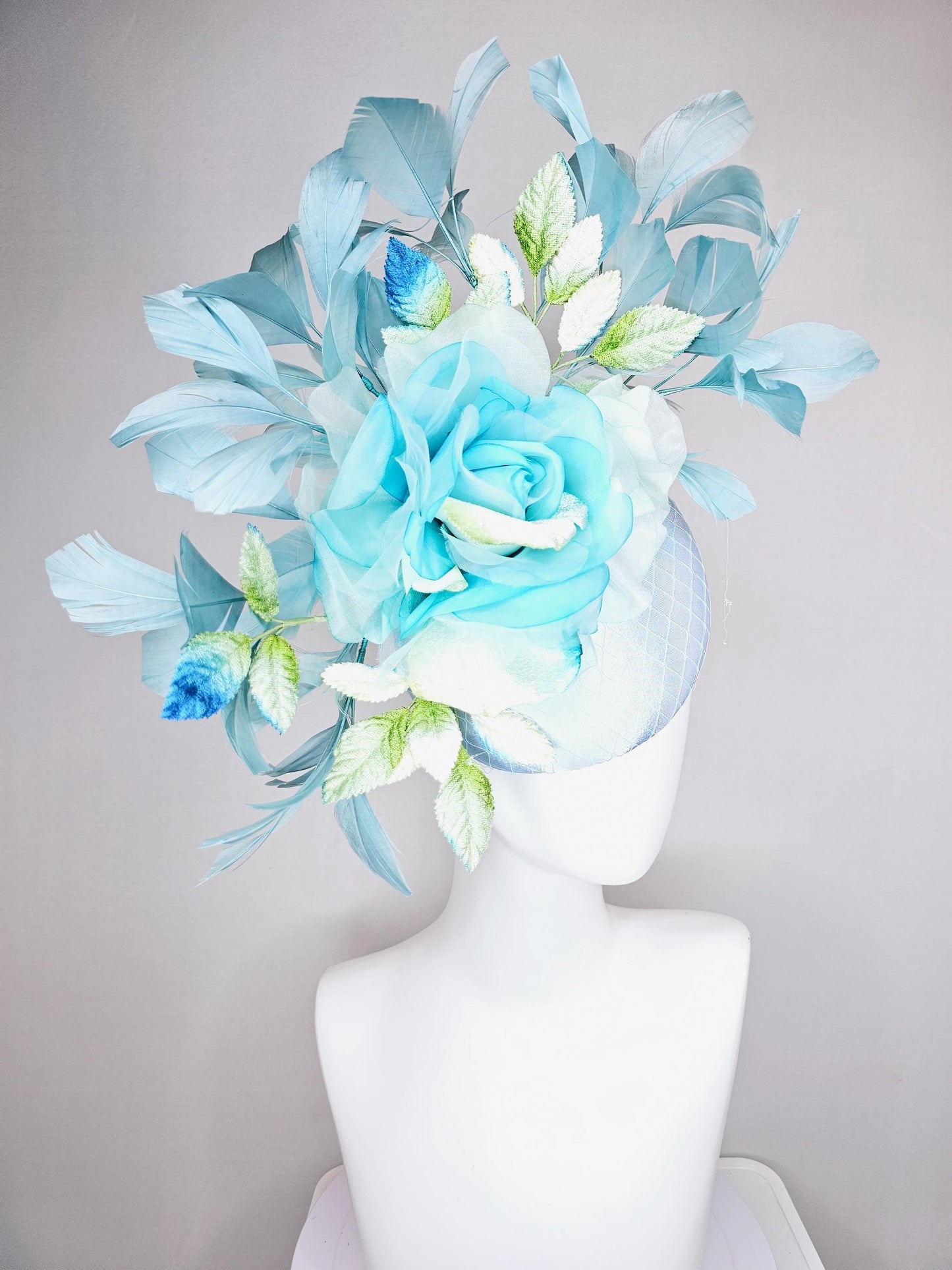 kentucky derby hat fascinator light blue satin with netting, sky blue organza rose flower,blue and green leaves,teal blue branching feathers