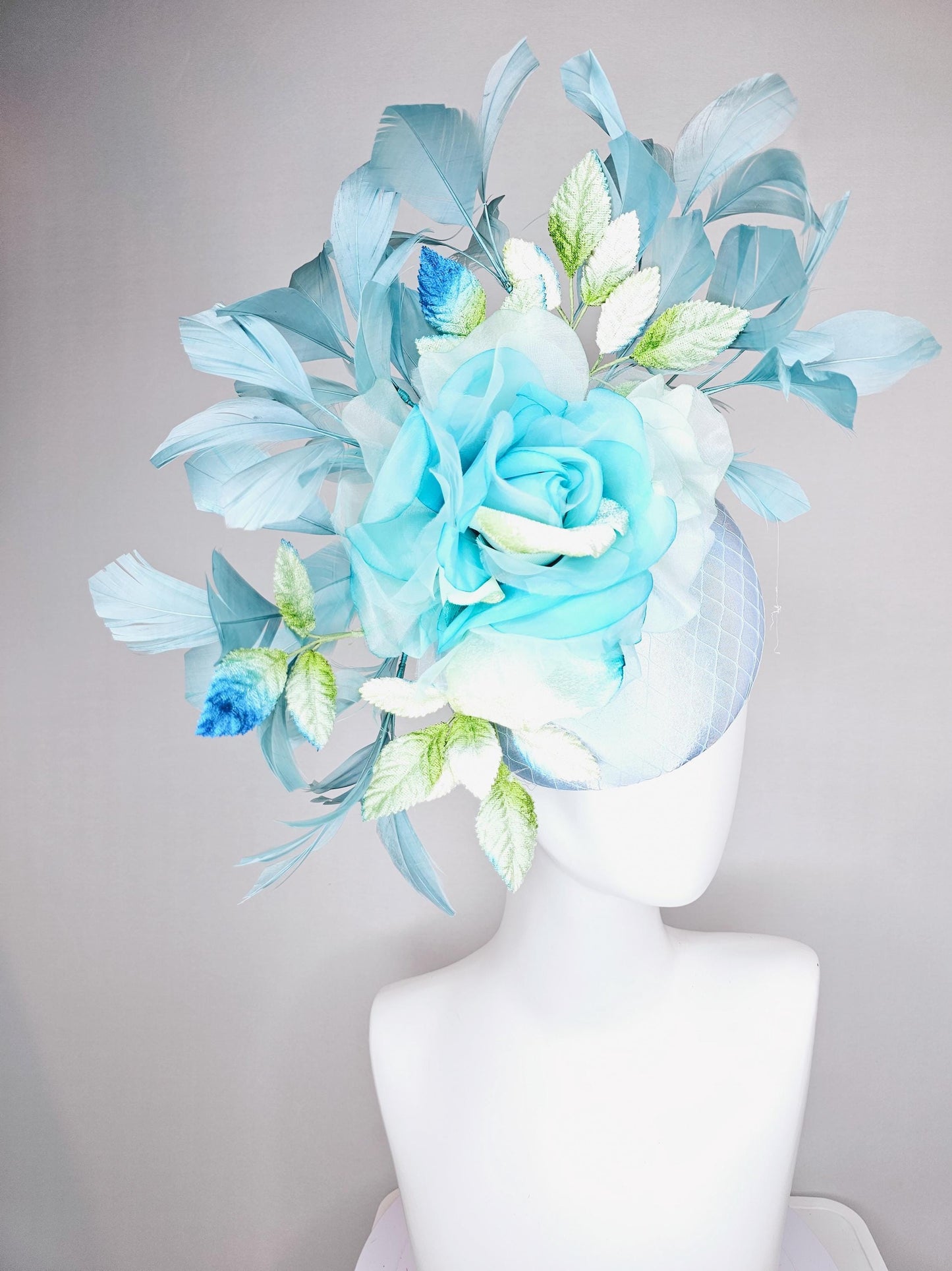 kentucky derby hat fascinator light blue satin with netting, sky blue organza rose flower,blue and green leaves,teal blue branching feathers