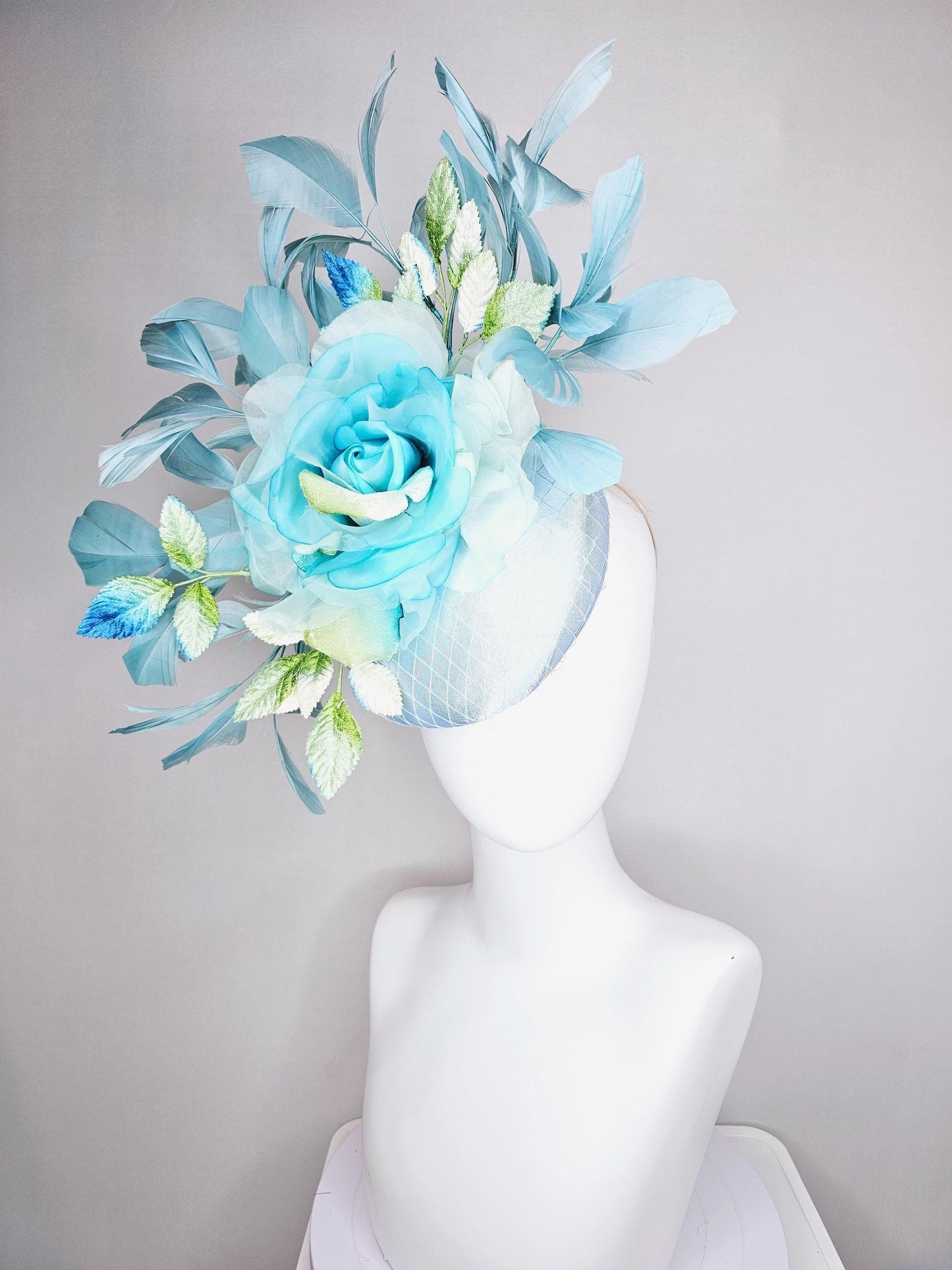 kentucky derby hat fascinator light blue satin with netting, sky blue organza rose flower,blue and green leaves,teal blue branching feathers