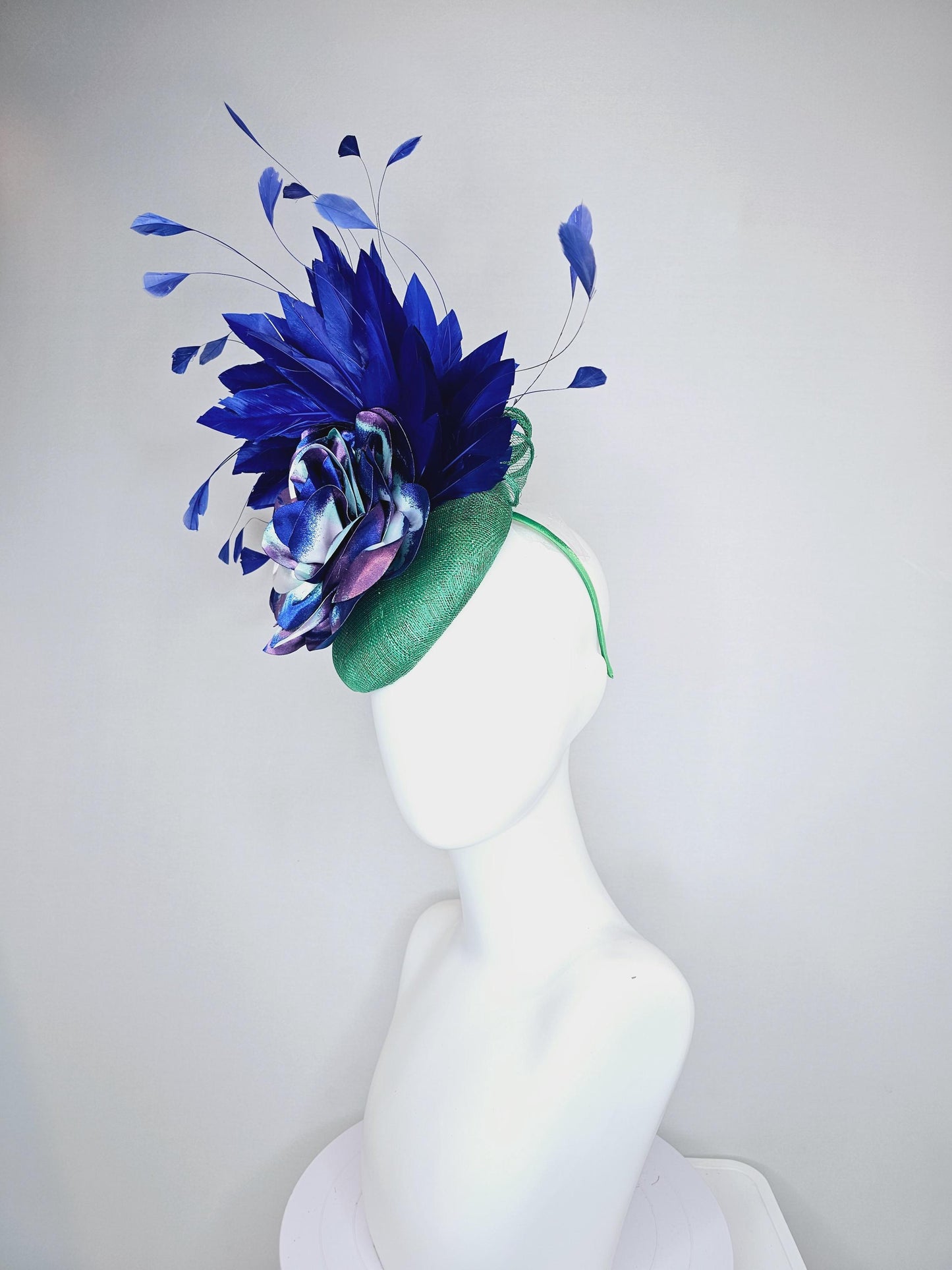 kentucky derby hat fascinator green sinamay, cobalt blue branching feathers and large blue,turquoise and purple ombre satin rose flower