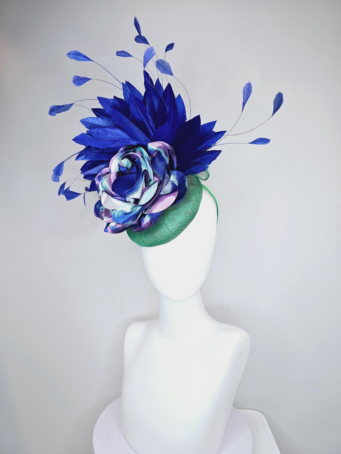 kentucky derby hat fascinator green sinamay, cobalt blue branching feathers and large blue,turquoise and purple ombre satin rose flower