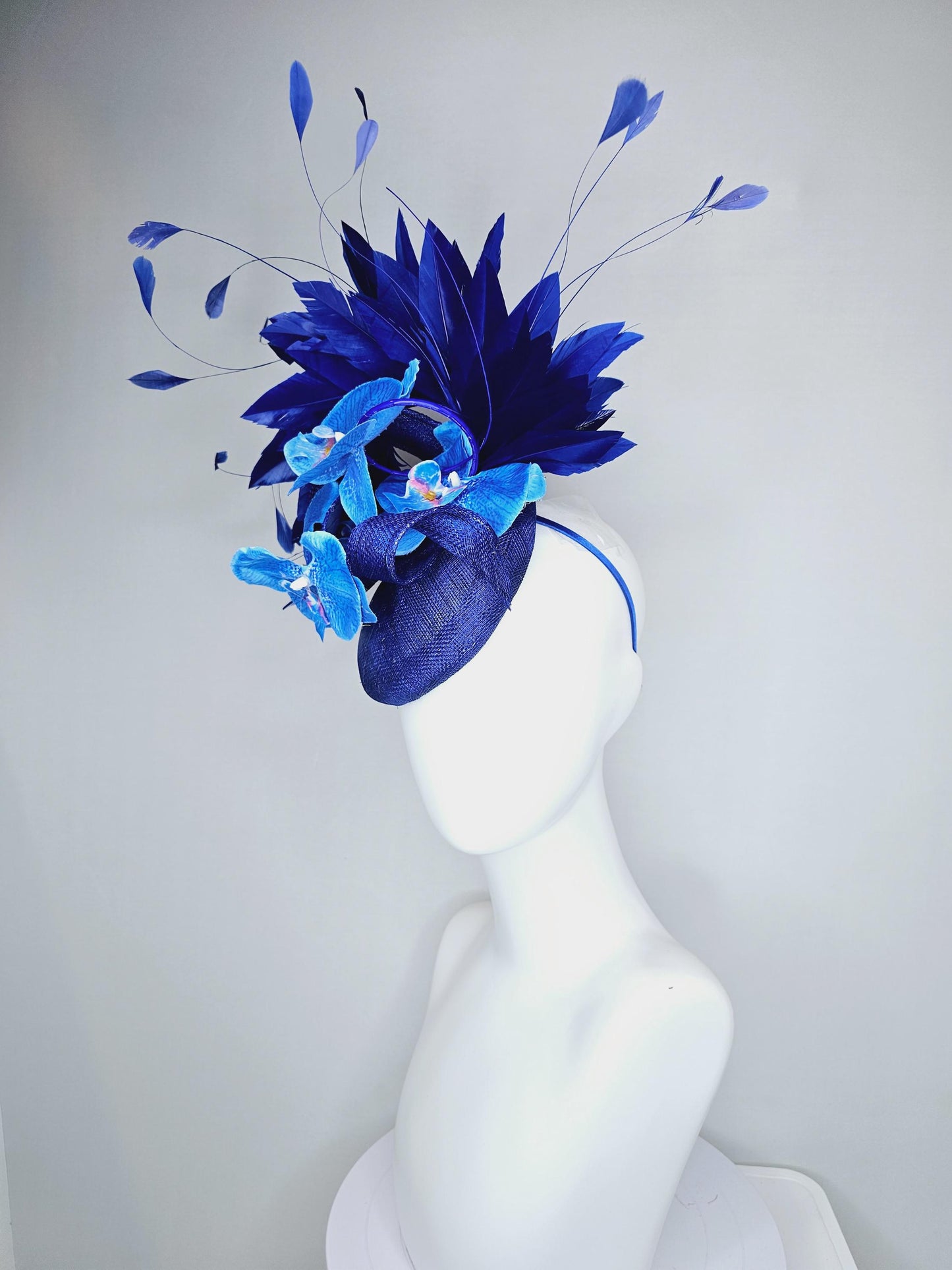 kentucky derby hat fascinator navy blue sinamay with curls, midnight royal blue branching feathers and large sky blue satin silk orchids