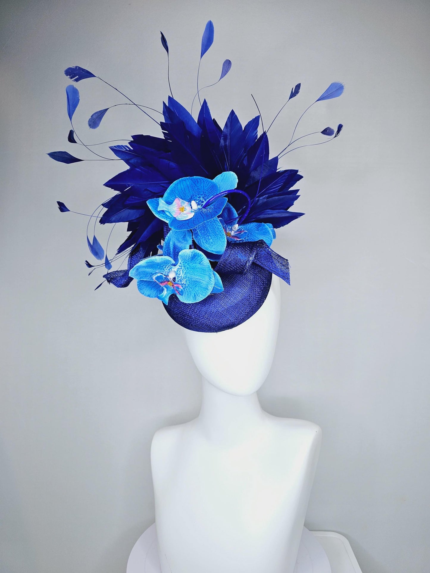 kentucky derby hat fascinator navy blue sinamay with curls, midnight royal blue branching feathers and large sky blue satin silk orchids