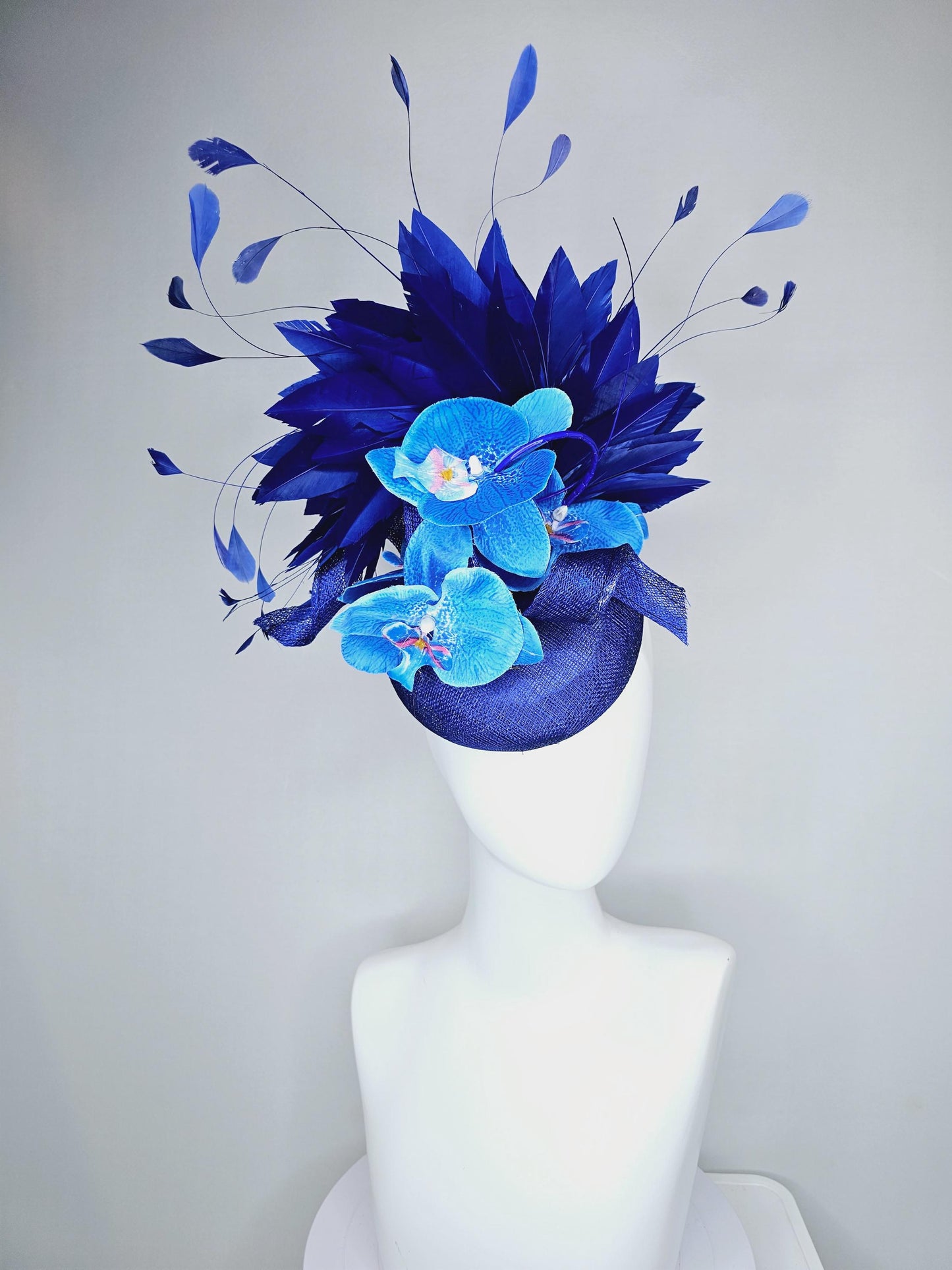 kentucky derby hat fascinator navy blue sinamay with curls, midnight royal blue branching feathers and large sky blue satin silk orchids