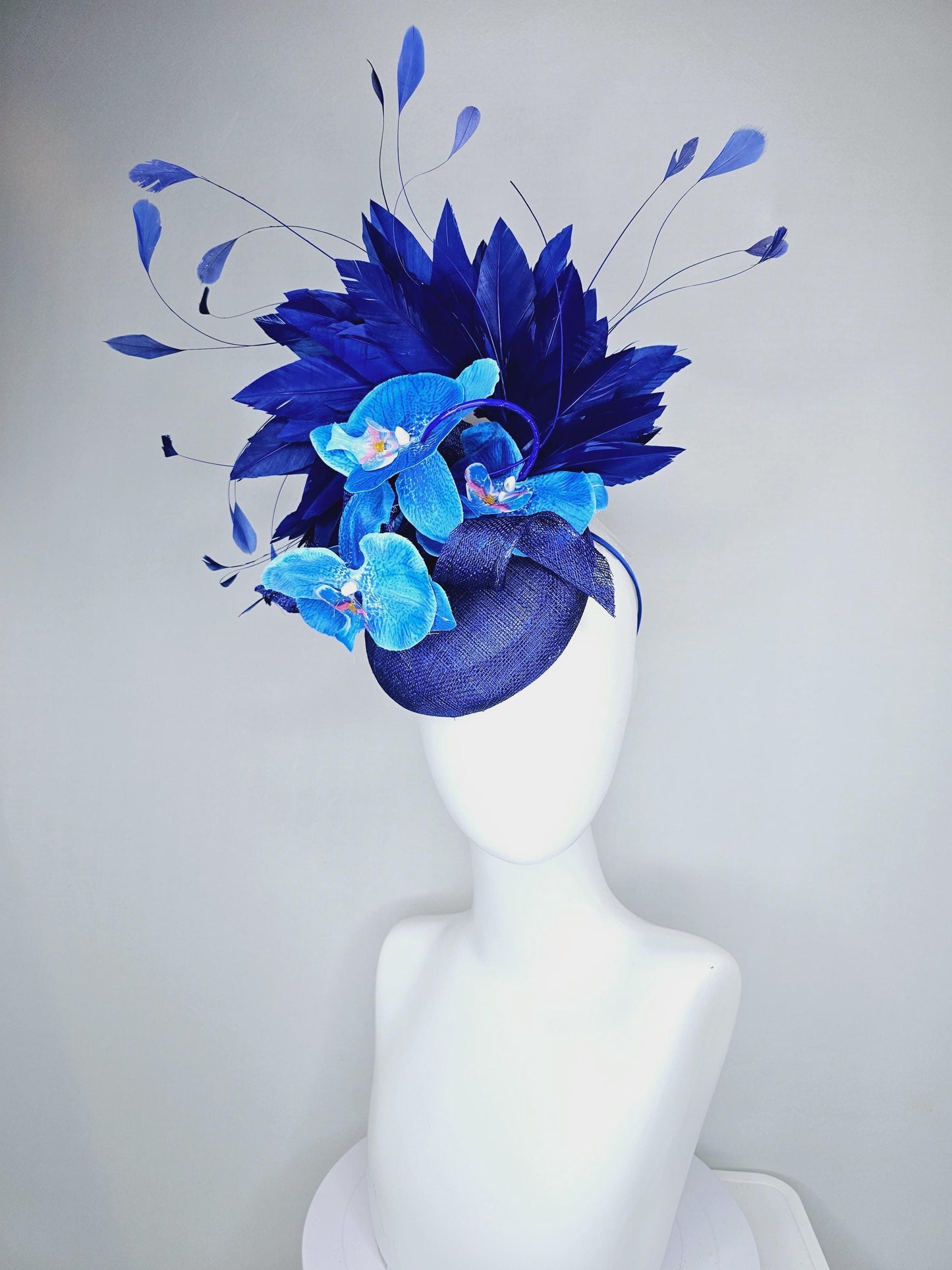 kentucky derby hat fascinator navy blue sinamay with curls, midnight royal blue branching feathers and large sky blue satin silk orchids