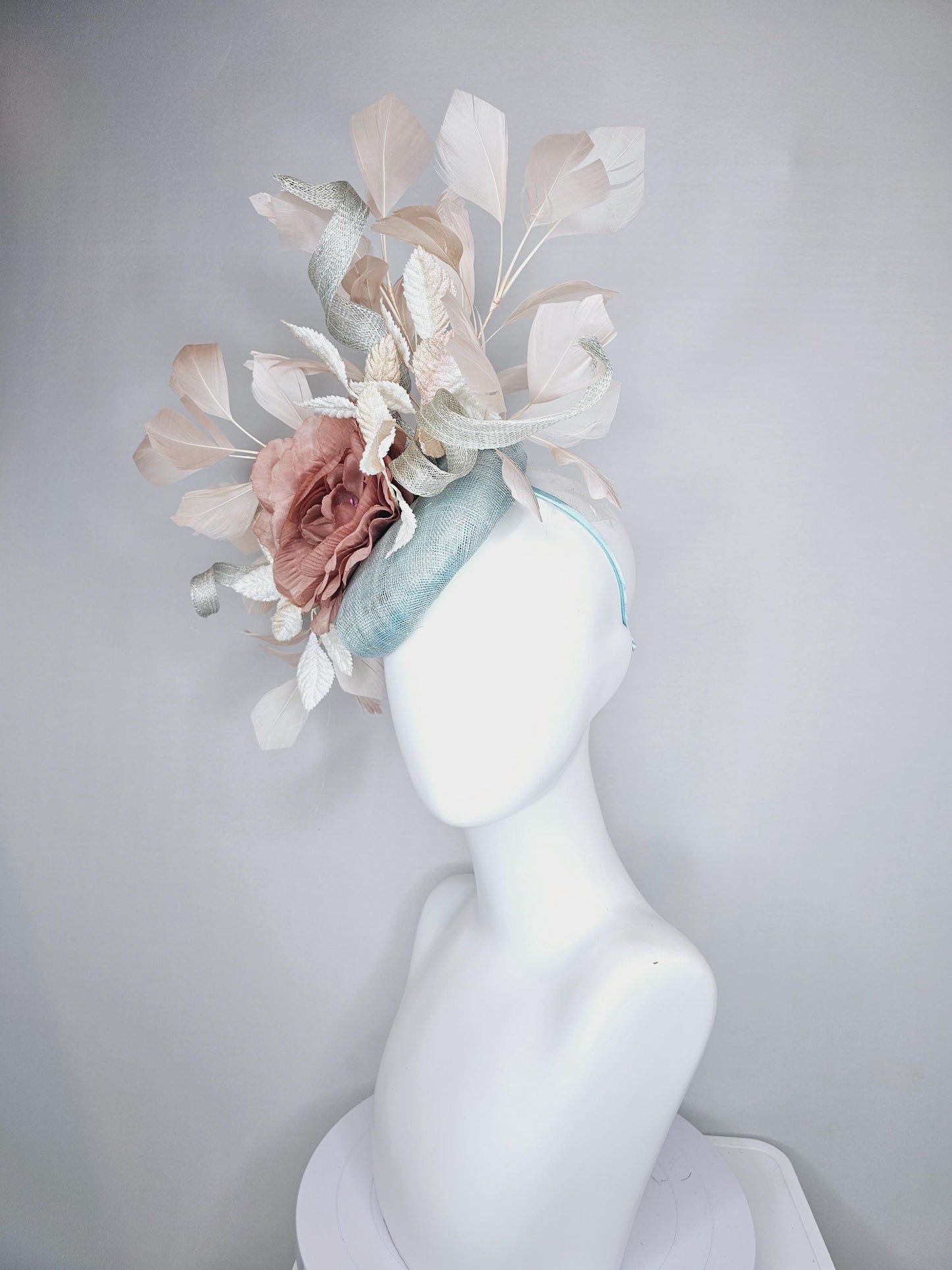 kentucky derby hat fascinator light blue sinamay with light beige branching feathers,cream velvet leaves, dusty pink rose silk satin flower