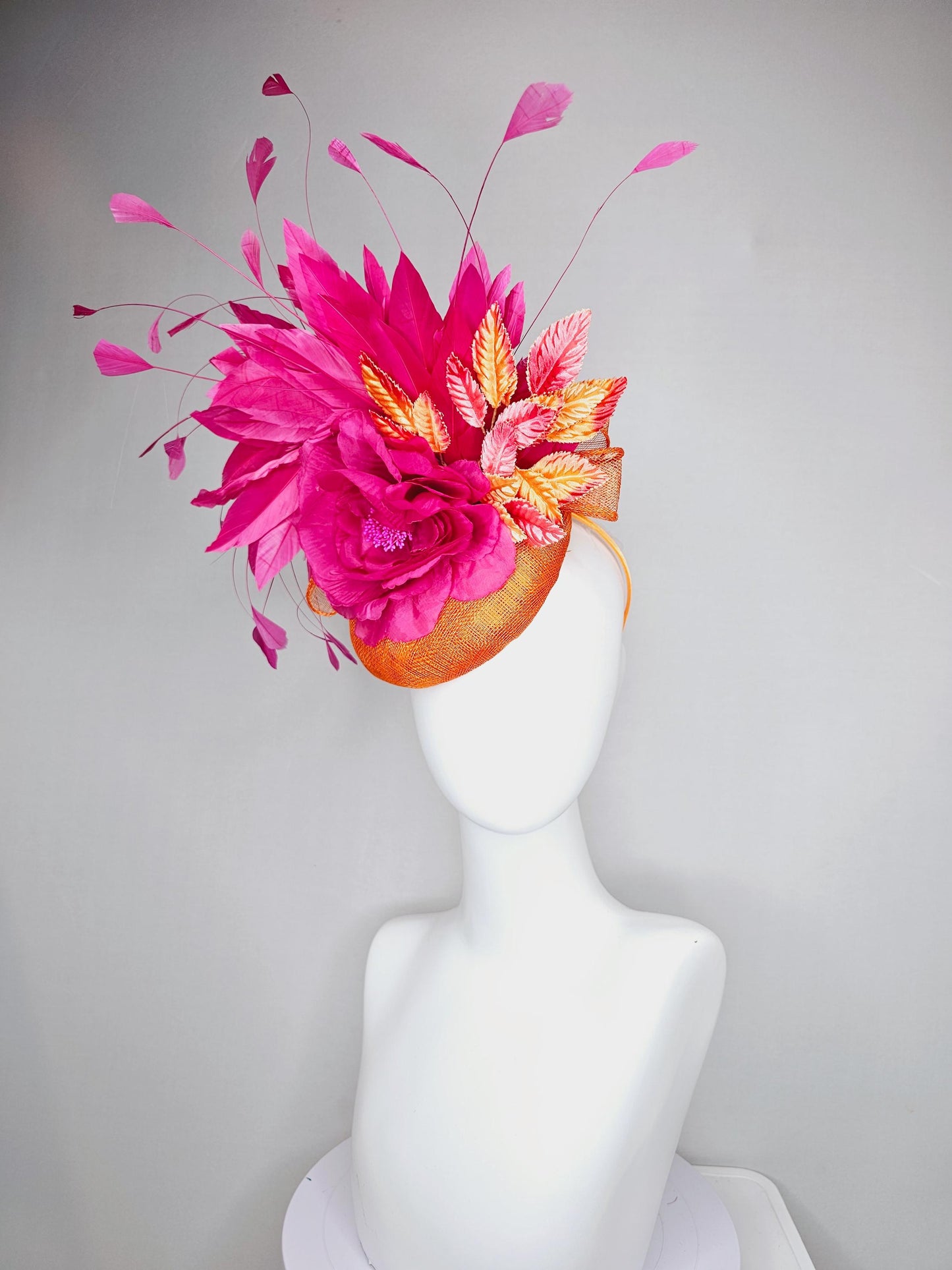 kentucky derby hat fascinator burnt orange sinamay with bright pink satin rose flower, red orange leaves, bright pink branching feathers