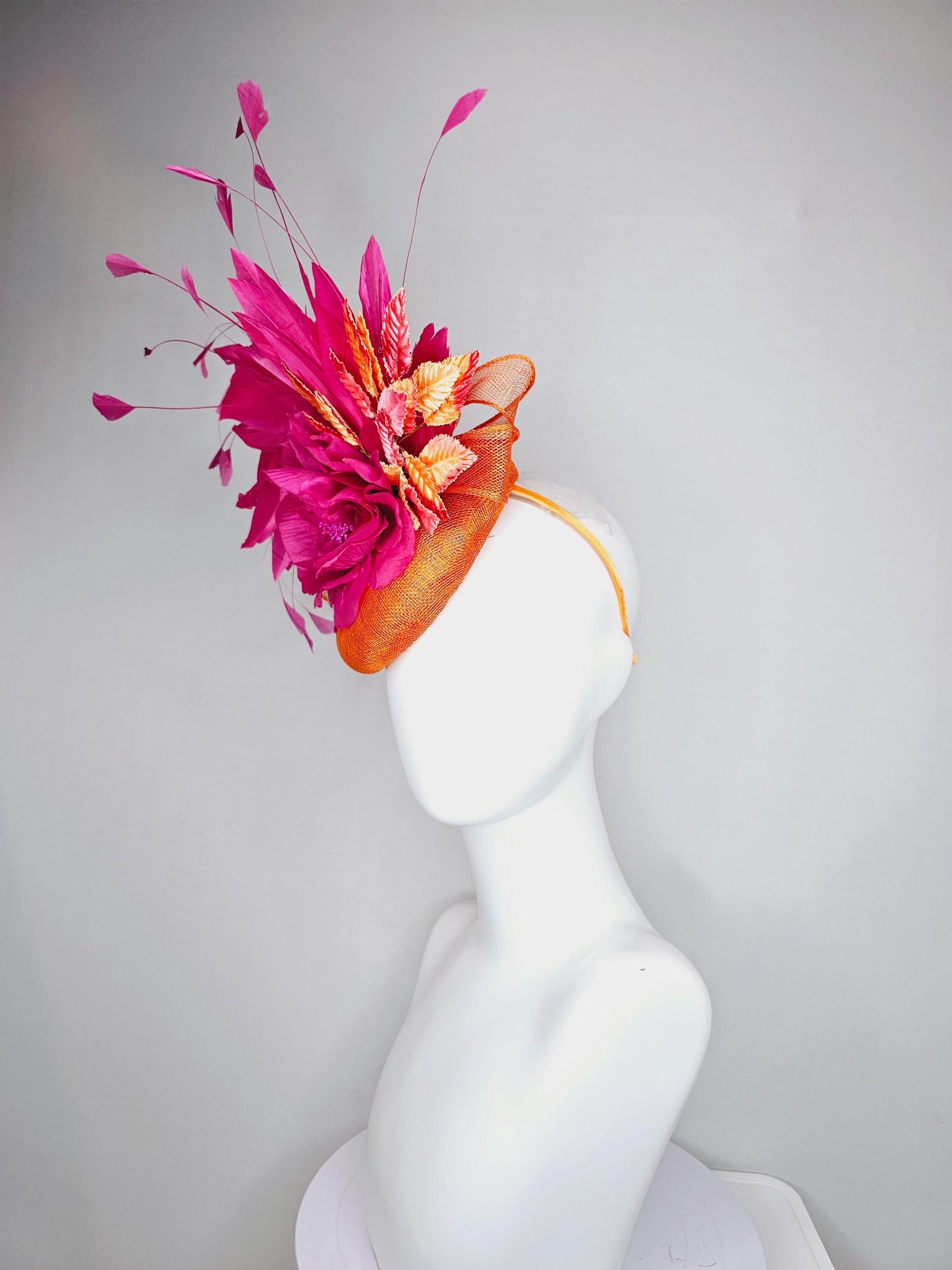 kentucky derby hat fascinator burnt orange sinamay with bright pink satin rose flower, red orange leaves, bright pink branching feathers