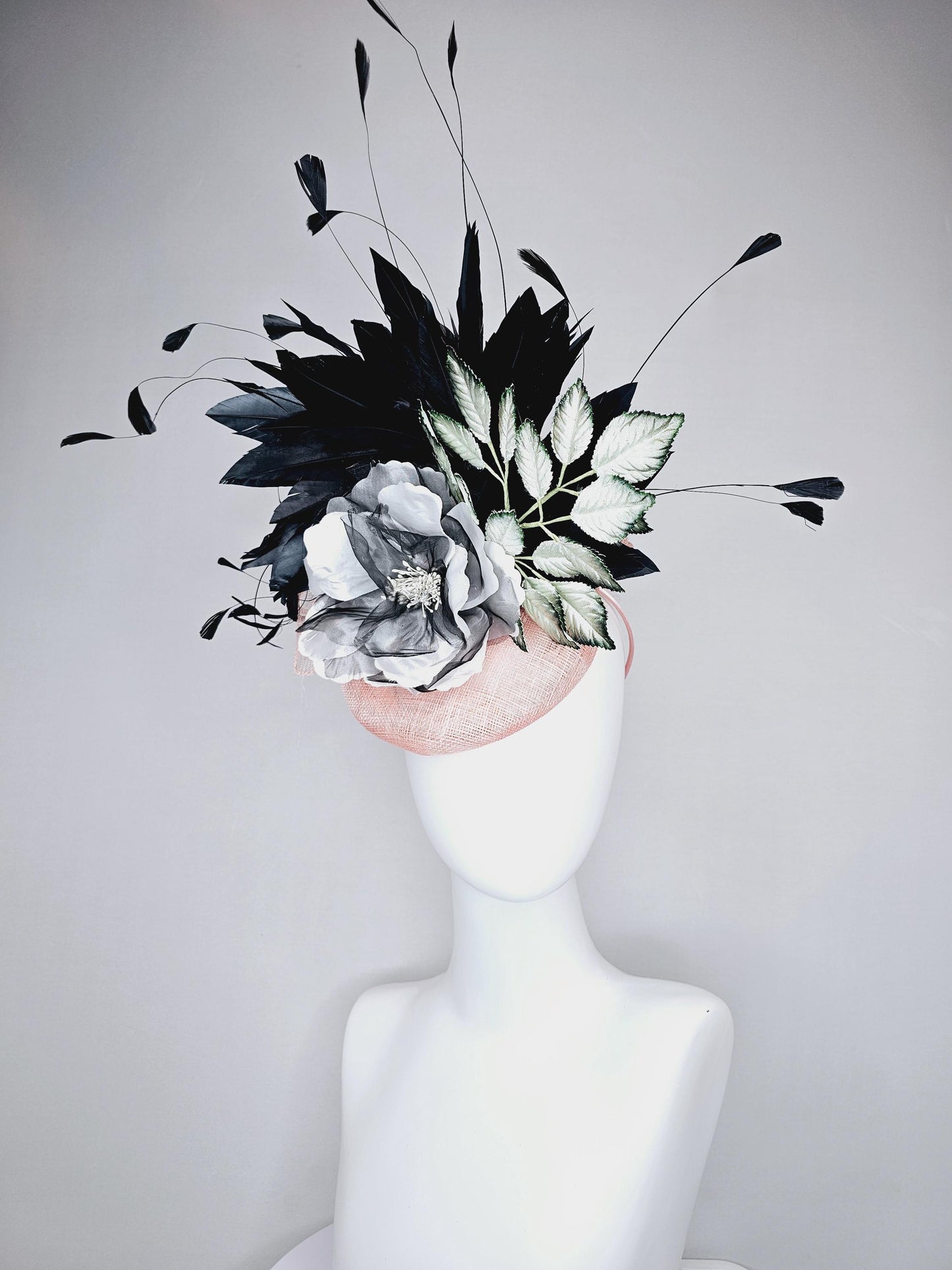 kentucky derby hat fascinator light pink sinamay with black and white organza flower, ombre black green leaves, black branching feathers