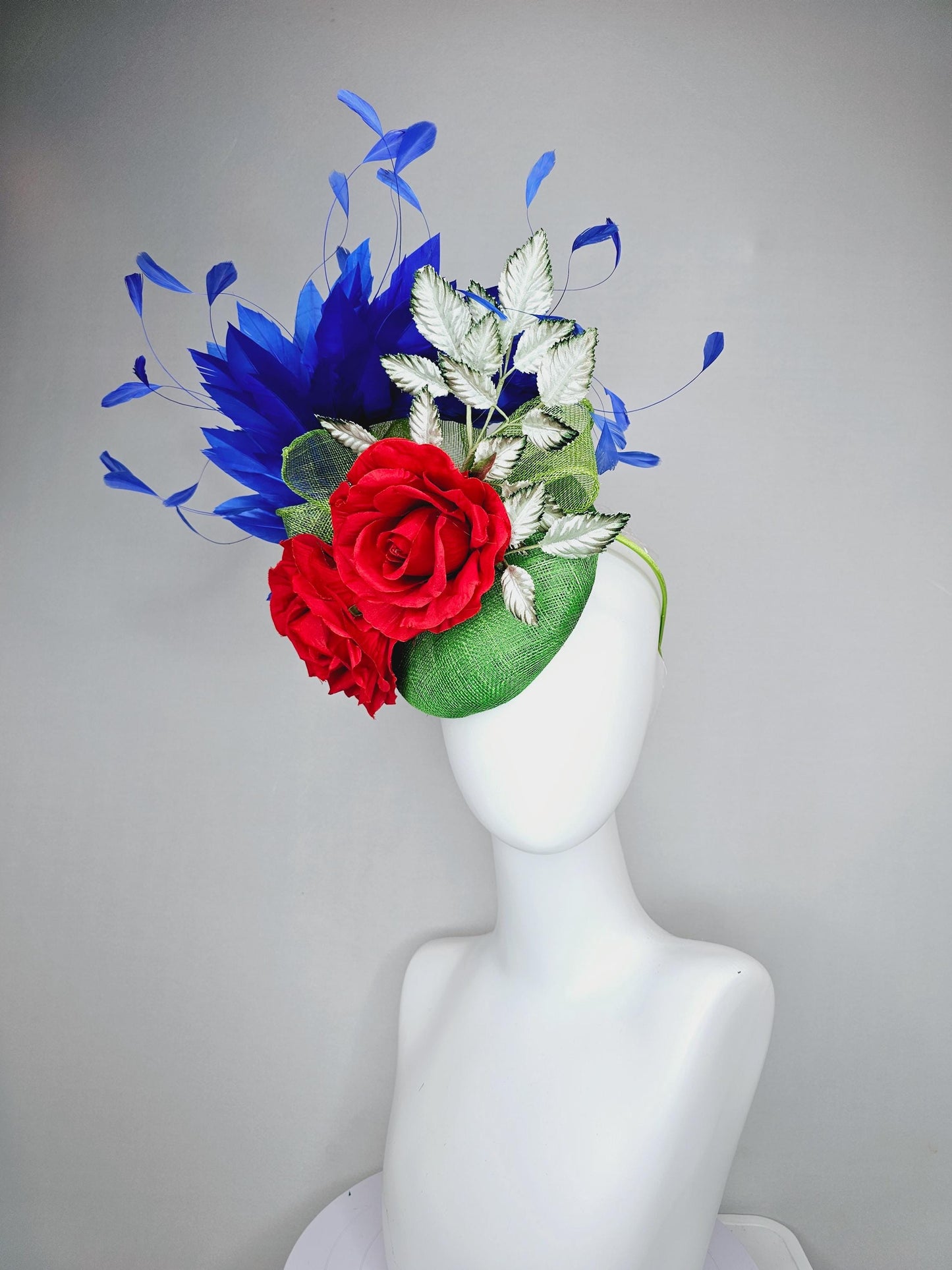 kentucky derby hat fascinator green sinamay with royal blue branching feathers,light green ombre leaves and bright red satin silk roses