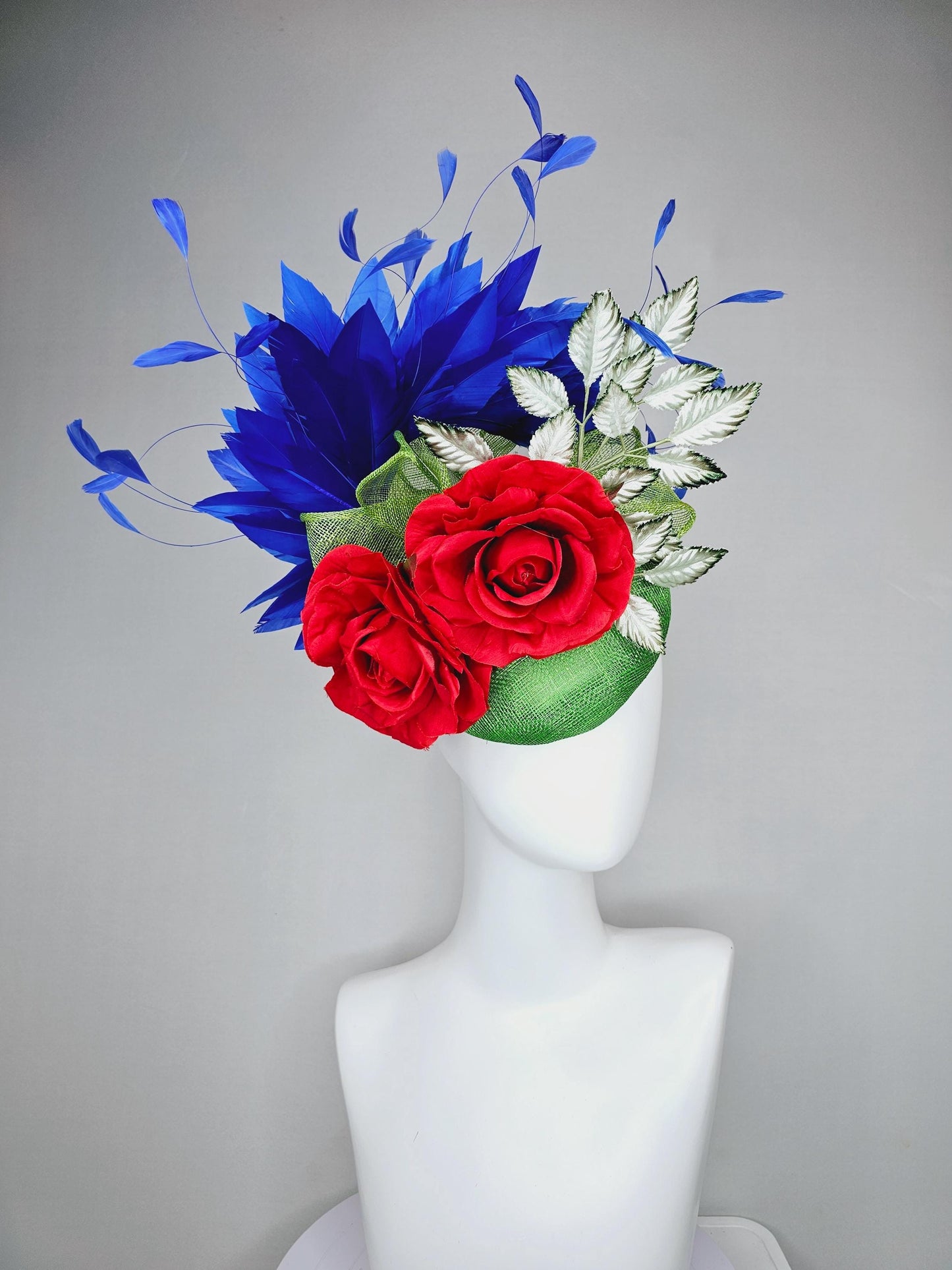 kentucky derby hat fascinator green sinamay with royal blue branching feathers,light green ombre leaves and bright red satin silk roses