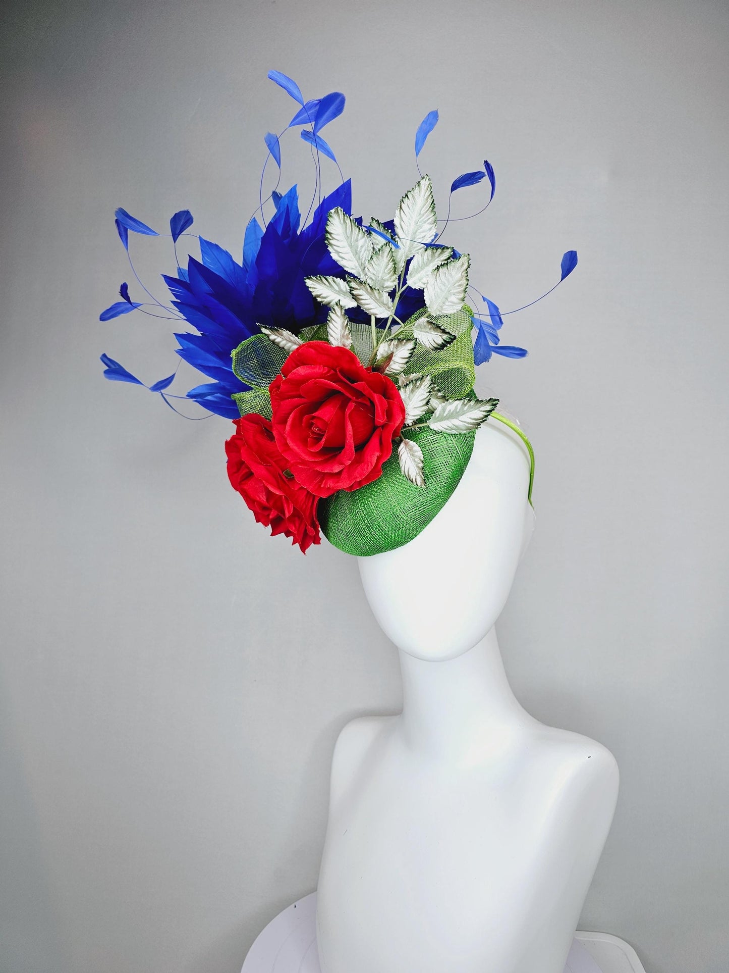 kentucky derby hat fascinator green sinamay with royal blue branching feathers,light green ombre leaves and bright red satin silk roses