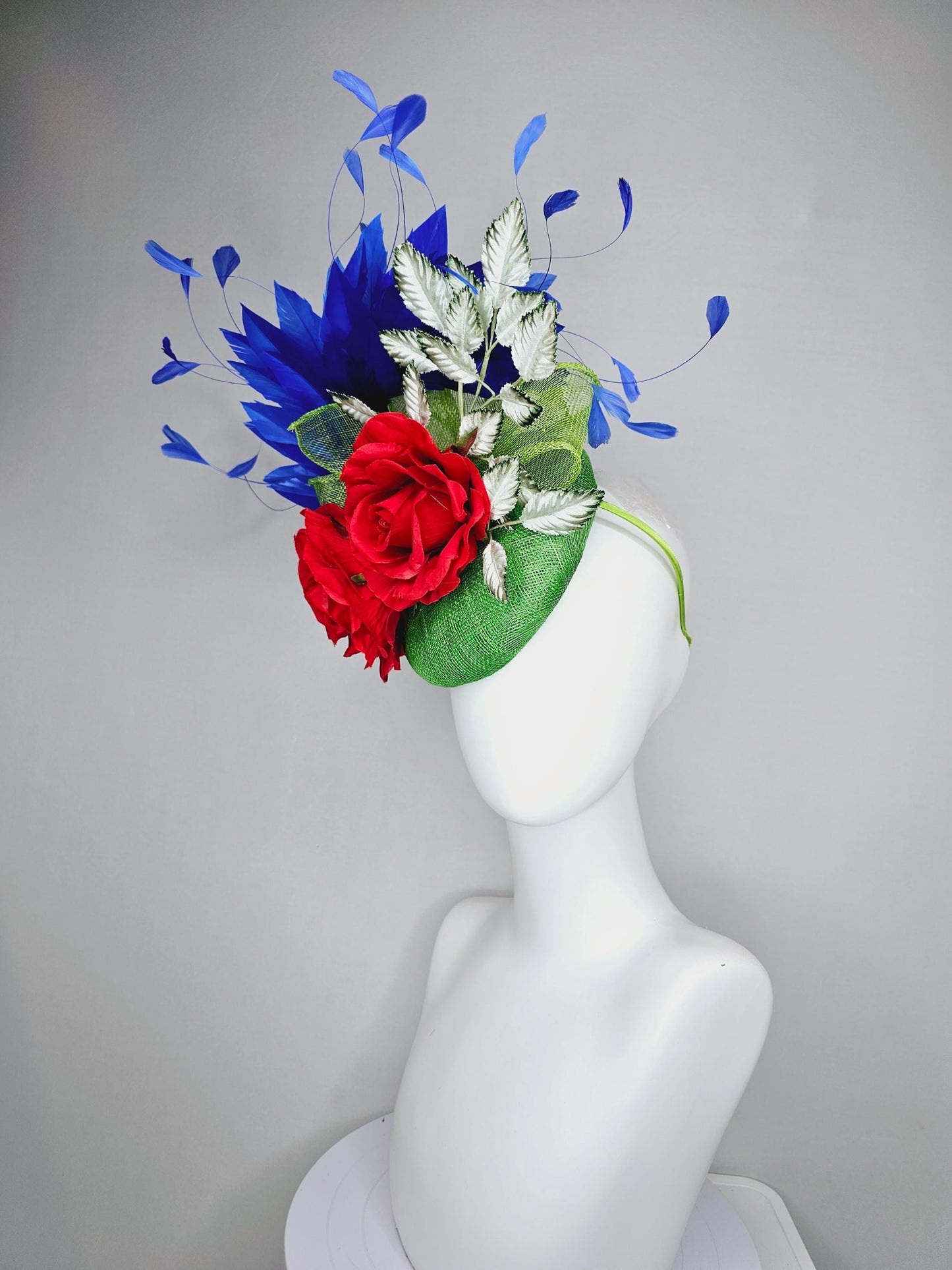 kentucky derby hat fascinator green sinamay with royal blue branching feathers,light green ombre leaves and bright red satin silk roses