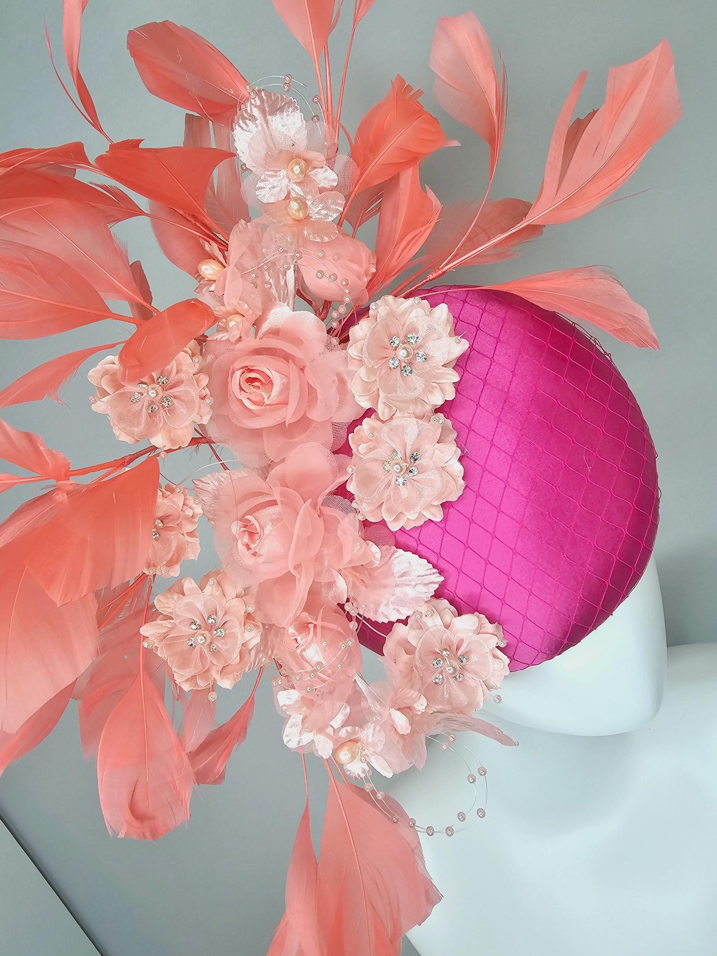 kentucky derby hat fascinator bright pink satin with netting, light blush pink organza satin flowers,light pink leaves,coral orange feathers