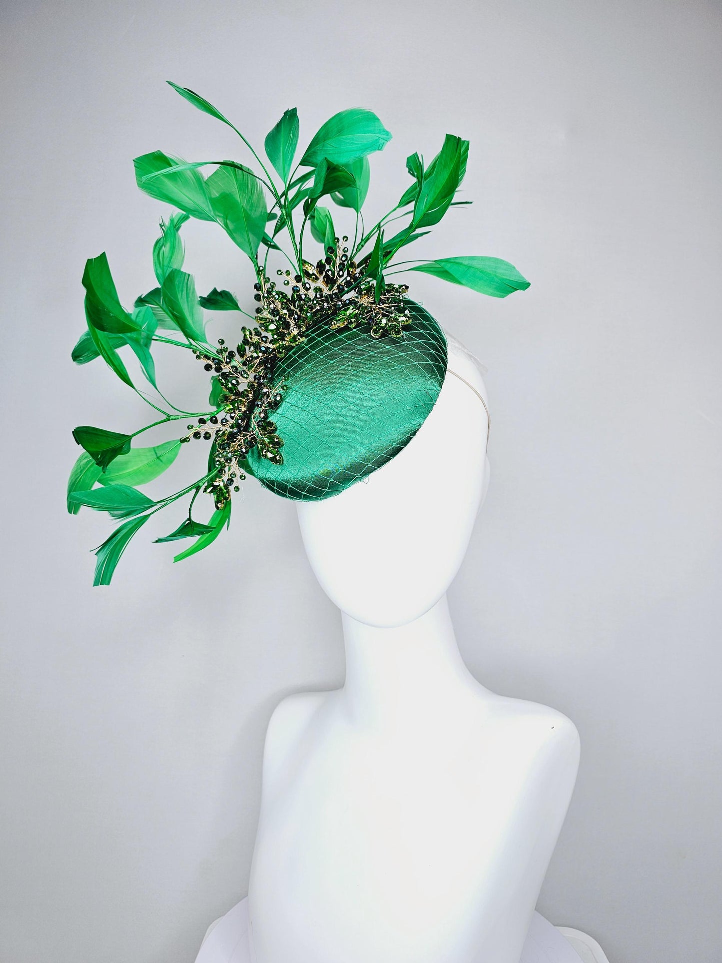 kentucky derby hat fascinator emerald green satin with netting and green crystal beaded jewels stems, emerald green branching feathers