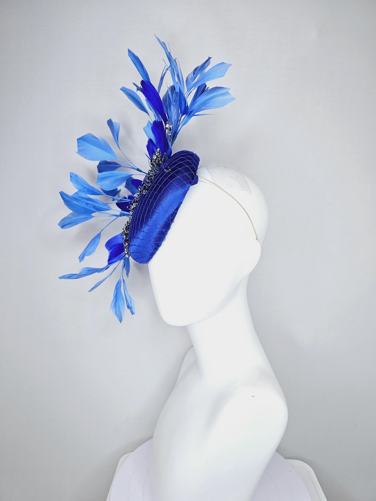 kentucky derby hat fascinator royal blue satin with netting and royal blue crystal beaded jewels stems, royal cobalt blue branching feathers