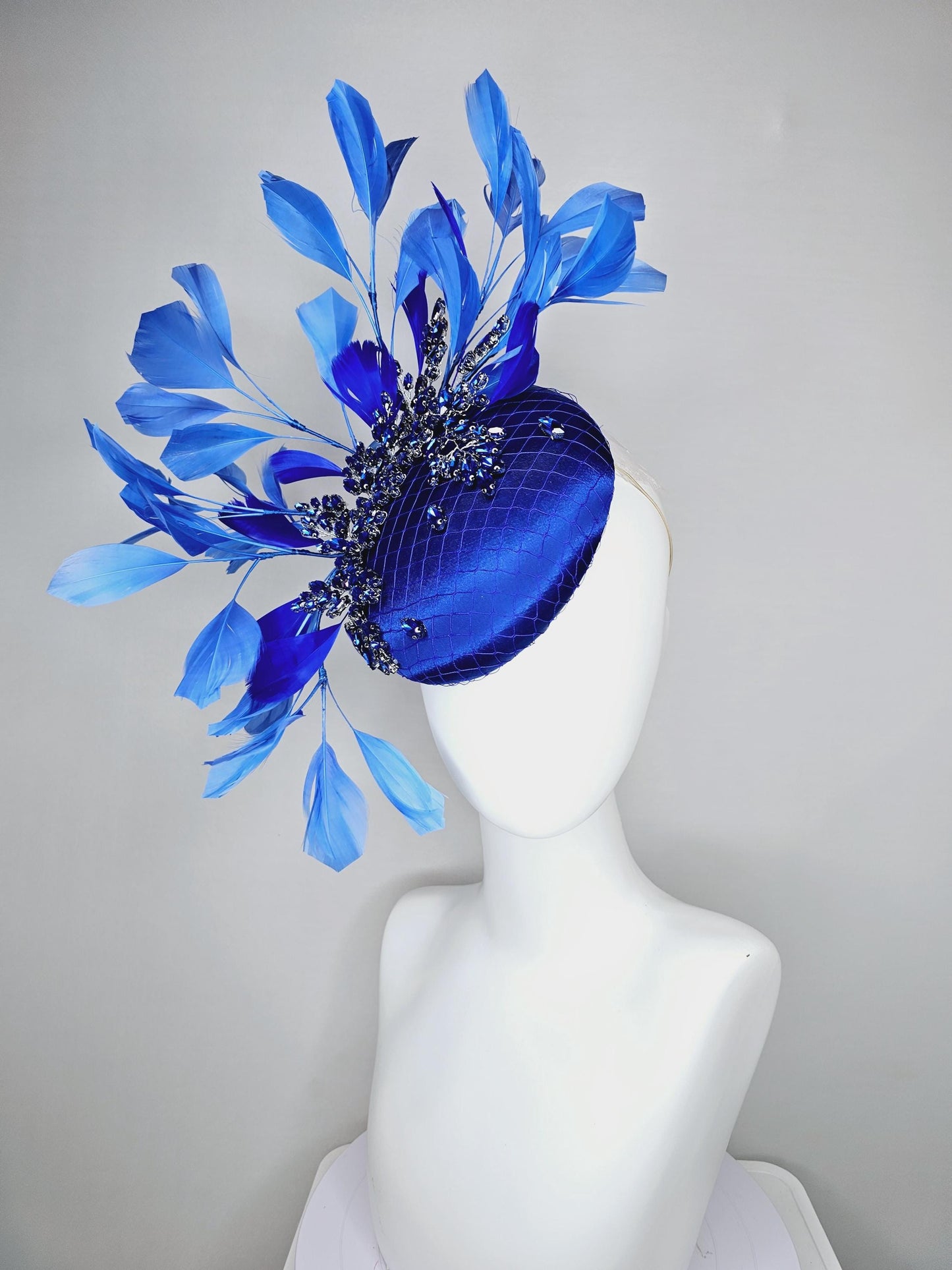 kentucky derby hat fascinator royal blue satin with netting and royal blue crystal beaded jewels stems, royal cobalt blue branching feathers