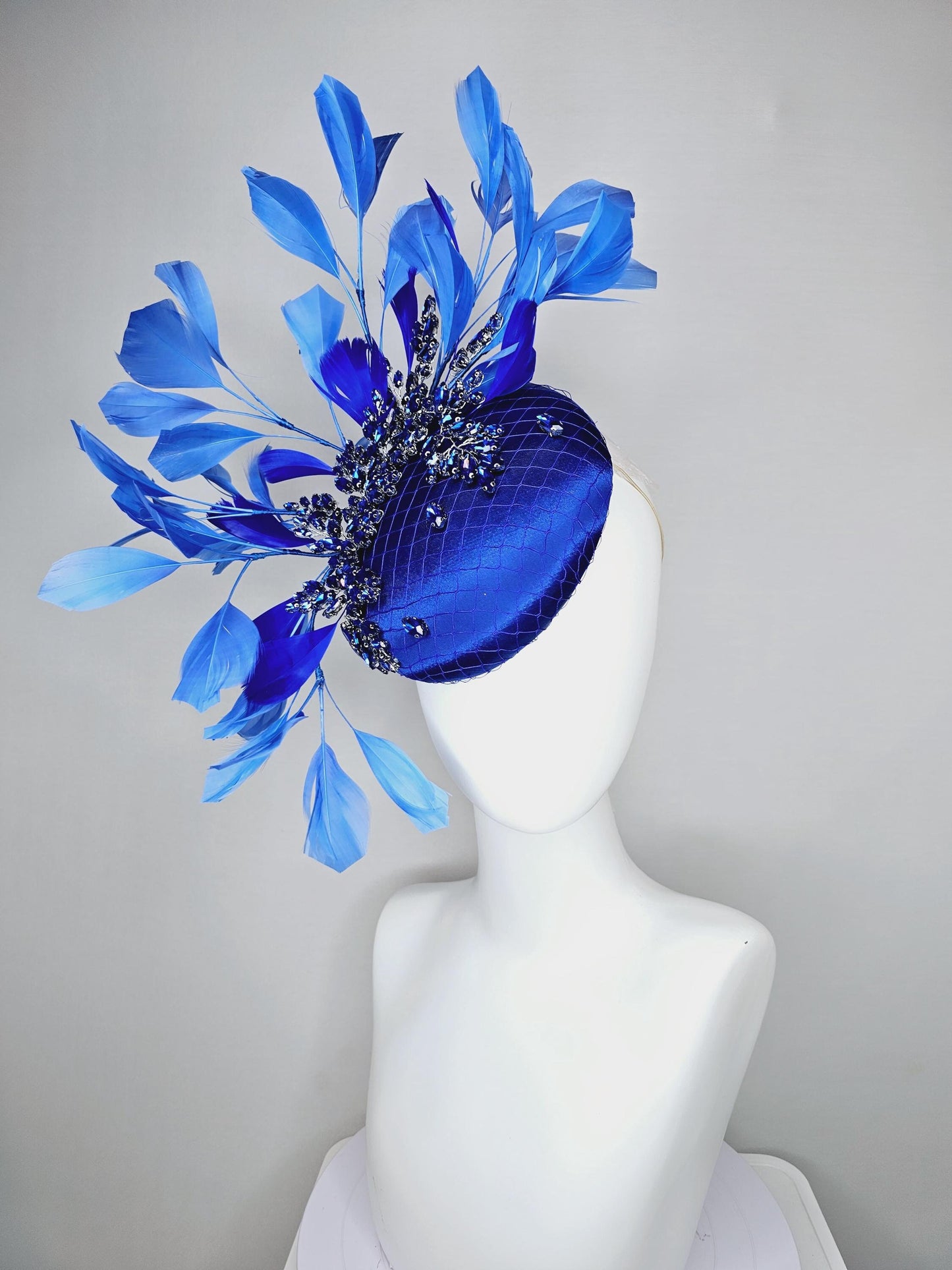 kentucky derby hat fascinator royal blue satin with netting and royal blue crystal beaded jewels stems, royal cobalt blue branching feathers