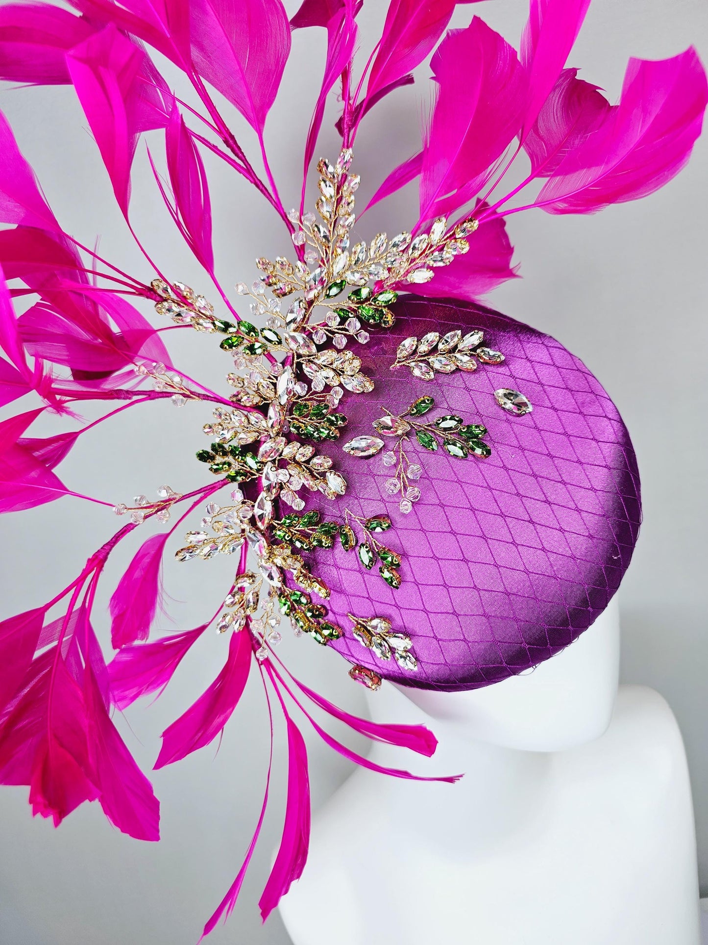 kentucky derby hat fascinator purple satin with netting,green and clear crystal beaded jewels stems,bright pink fuchsia branching feathers