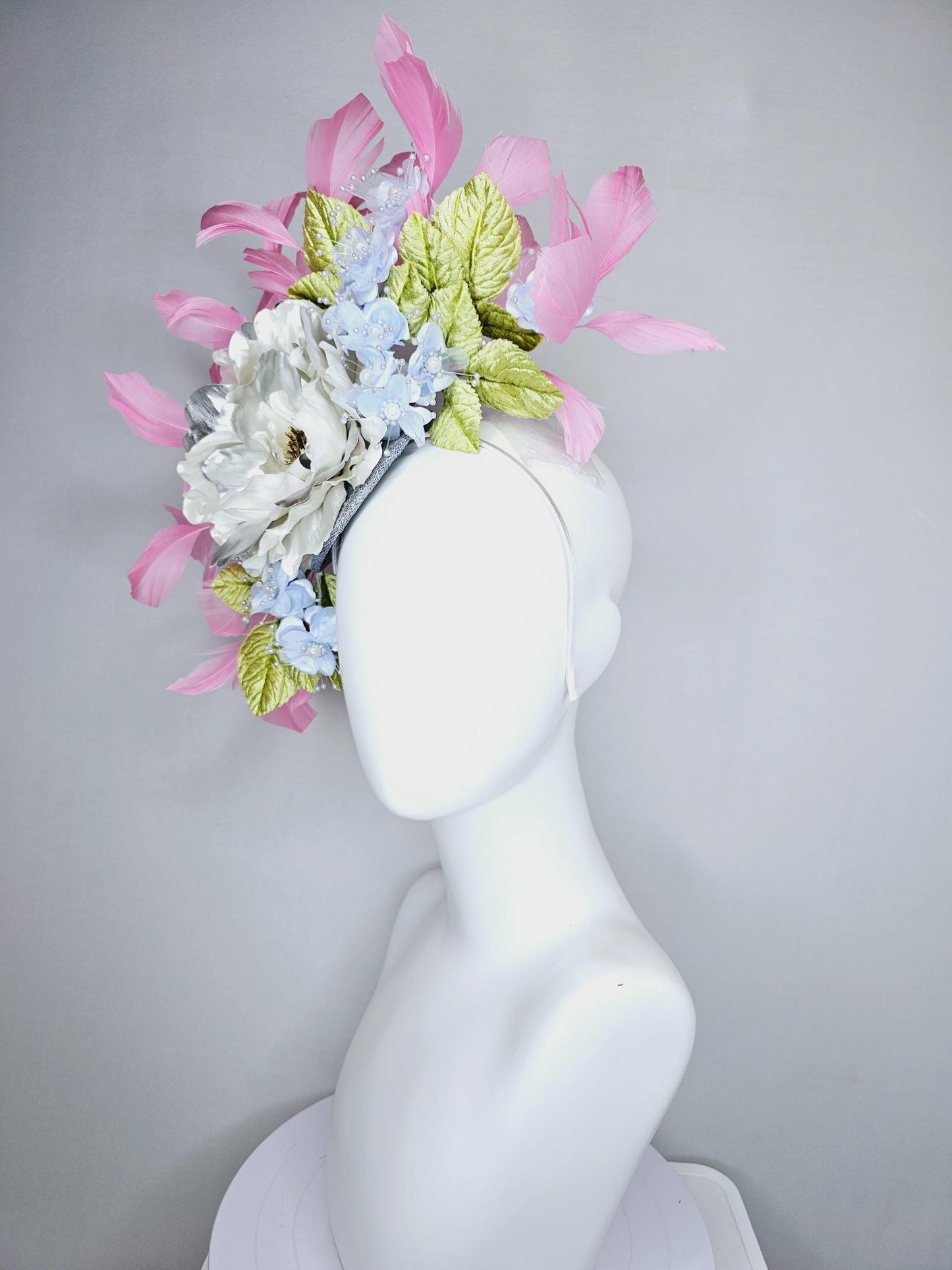 kentucky derby hat fascinator large white silver satin flower, small lavender blue organza satin flowers, green leaves, light pink feathers