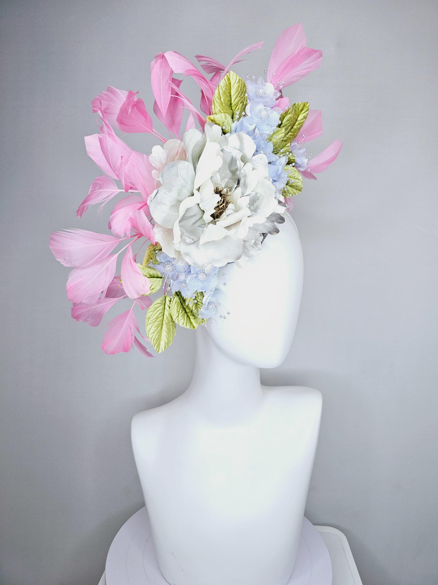 kentucky derby hat fascinator large white silver satin flower, small lavender blue organza satin flowers, green leaves, light pink feathers