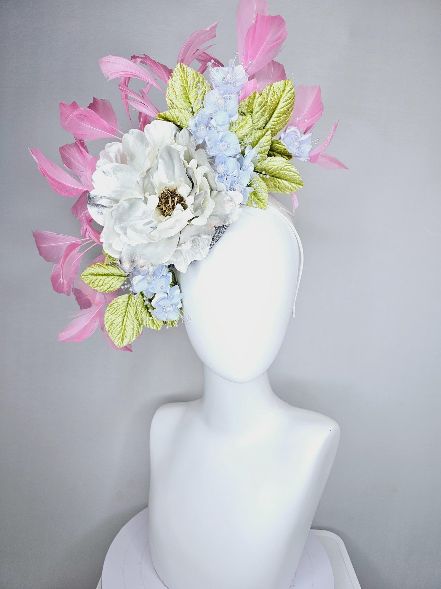 kentucky derby hat fascinator large white silver satin flower, small lavender blue organza satin flowers, green leaves, light pink feathers