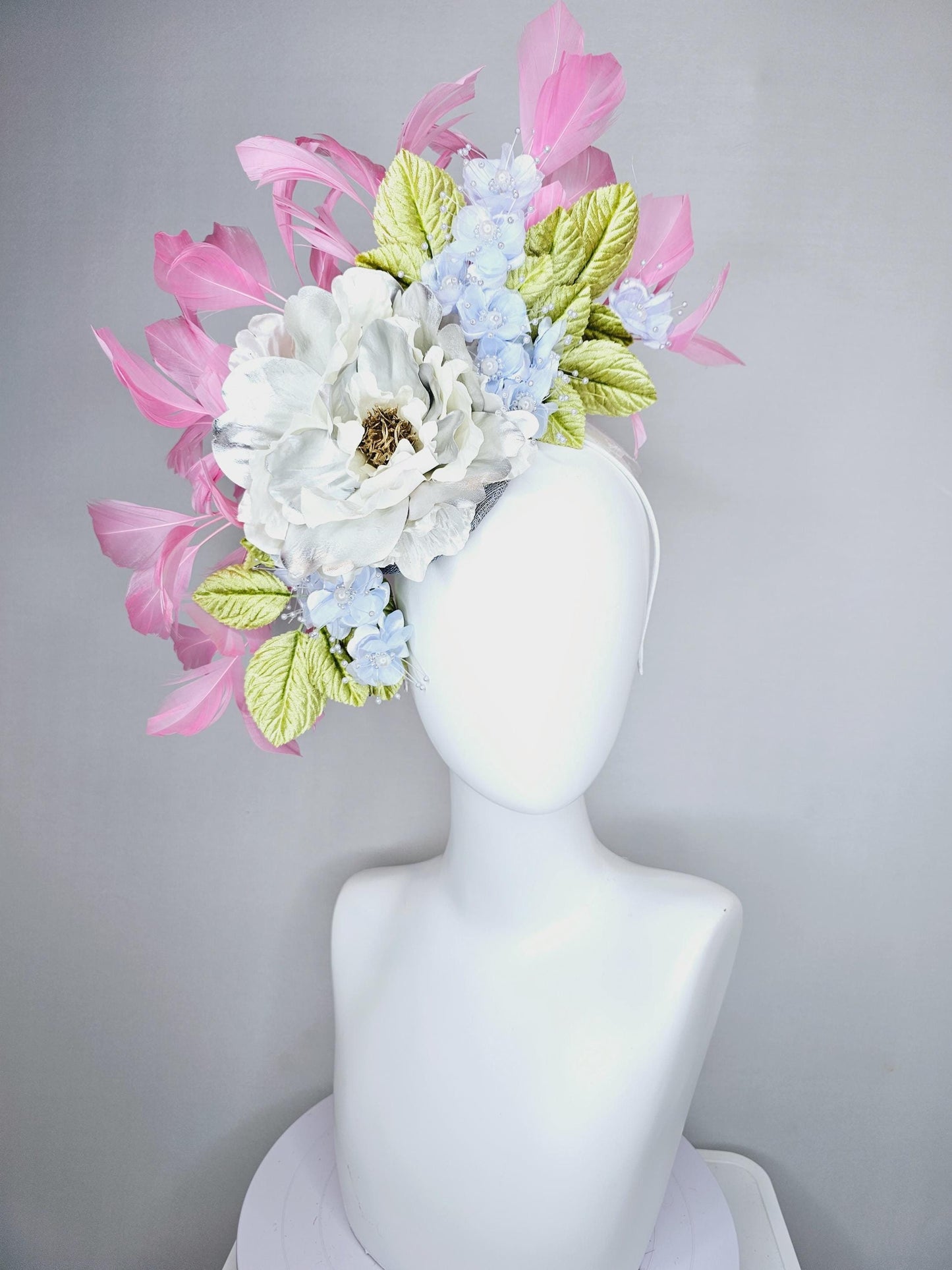 kentucky derby hat fascinator large white silver satin flower, small lavender blue organza satin flowers, green leaves, light pink feathers