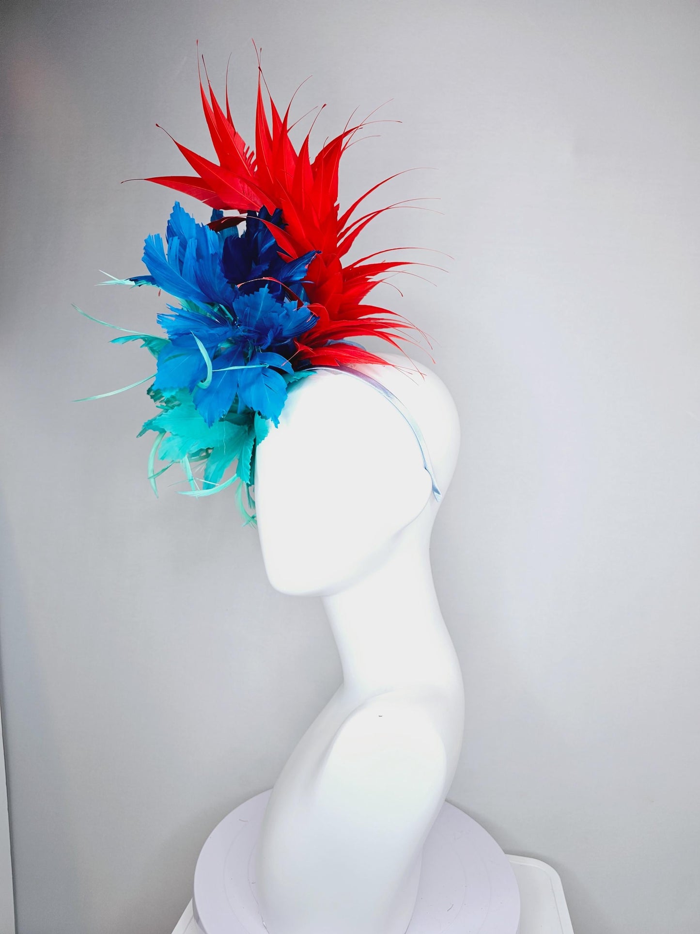 kentucky derby hat fascinator with fluffy aqua blue mint green cobalt blue zigzag feather flowers and red branching feathers