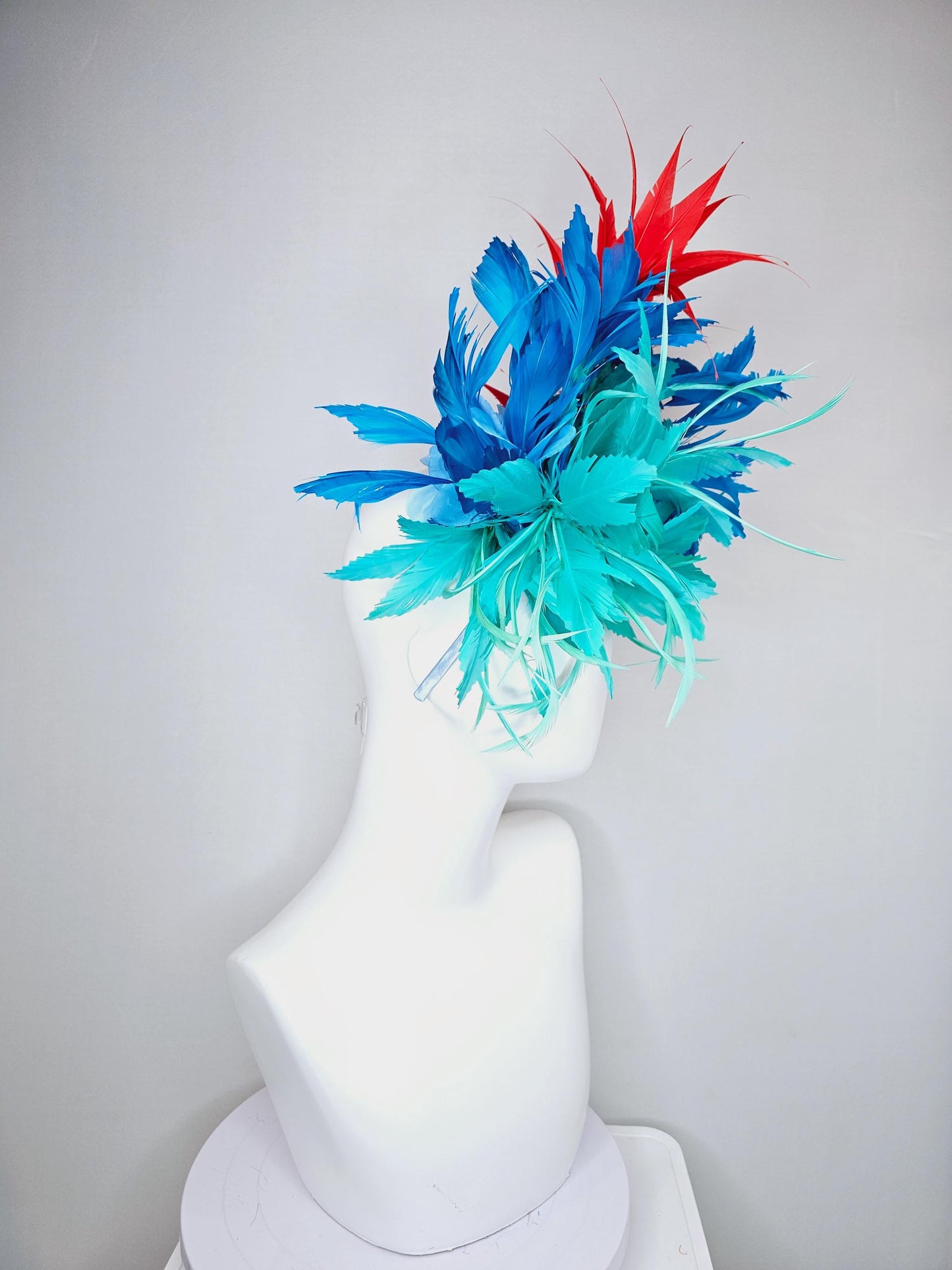 kentucky derby hat fascinator with fluffy aqua blue mint green cobalt blue zigzag feather flowers and red branching feathers