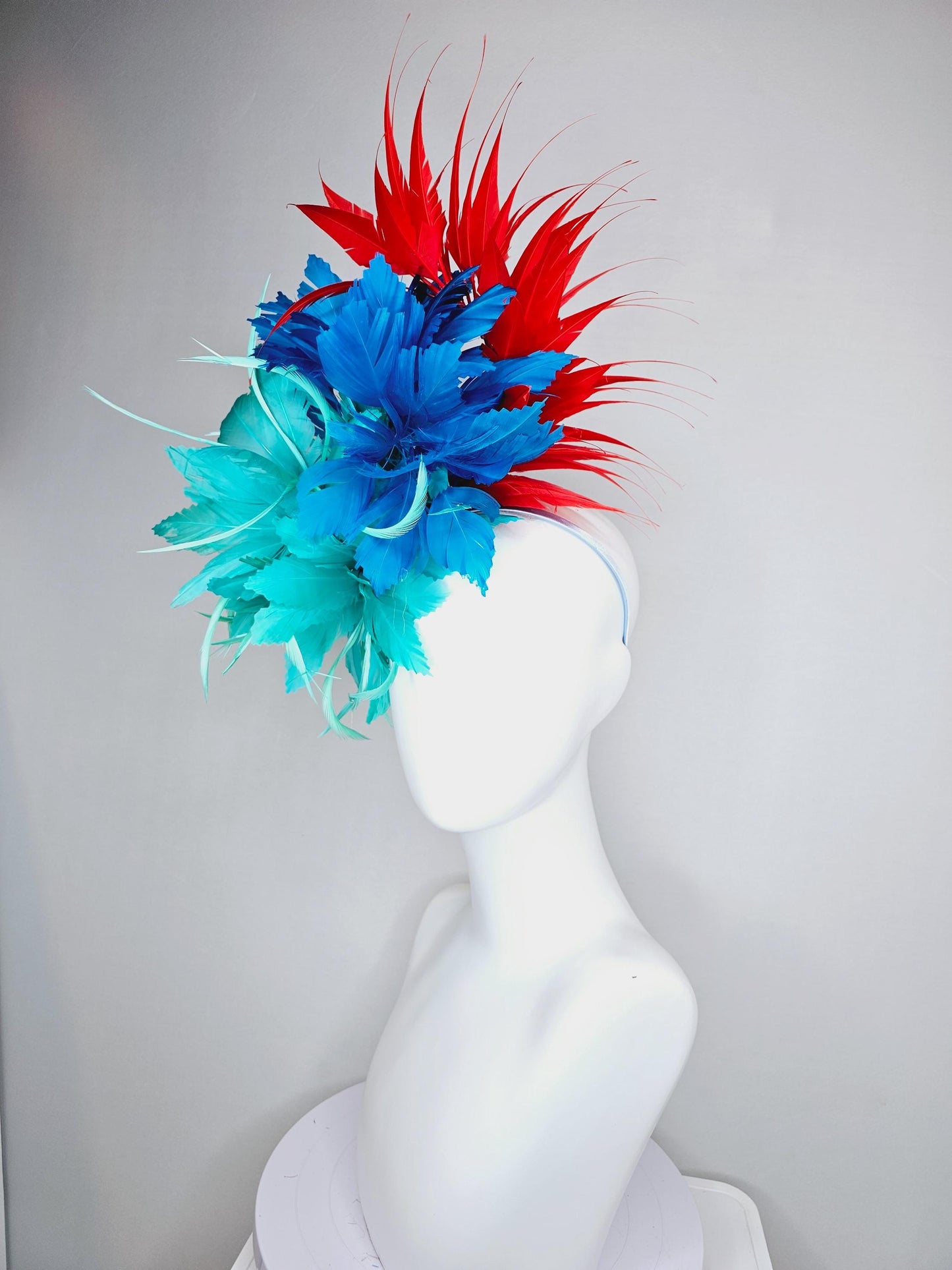 kentucky derby hat fascinator with fluffy aqua blue mint green cobalt blue zigzag feather flowers and red branching feathers