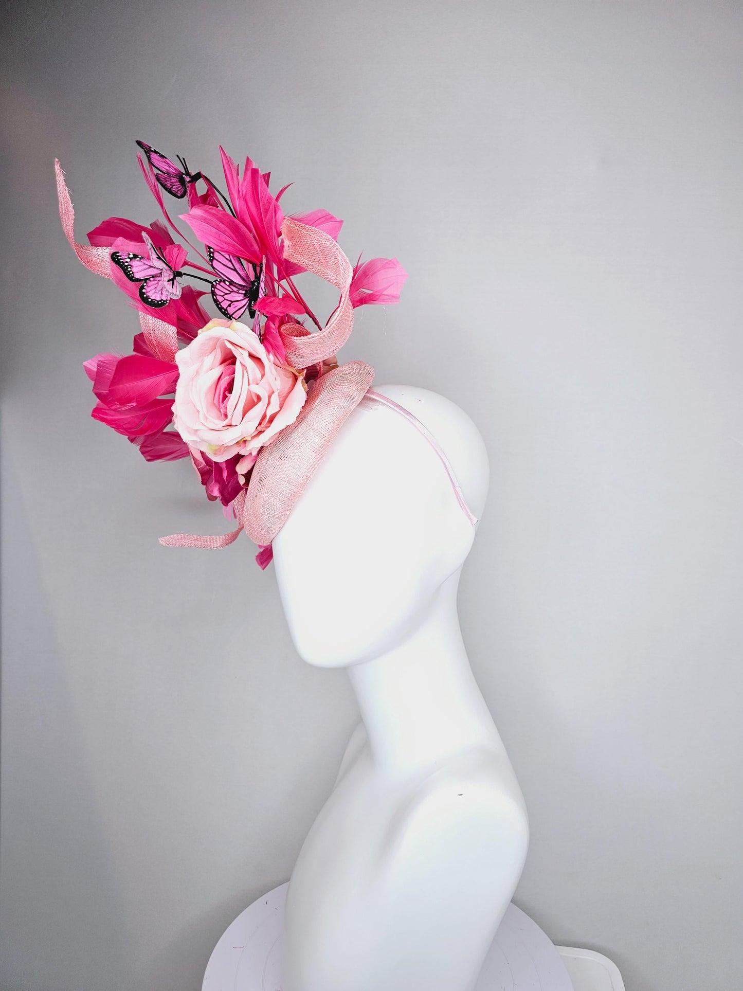 kentucky derby hat fascinator blush pink sinamay with sinamay curls, pink blush pink satin roses, pink feathers, pink and black butterflies