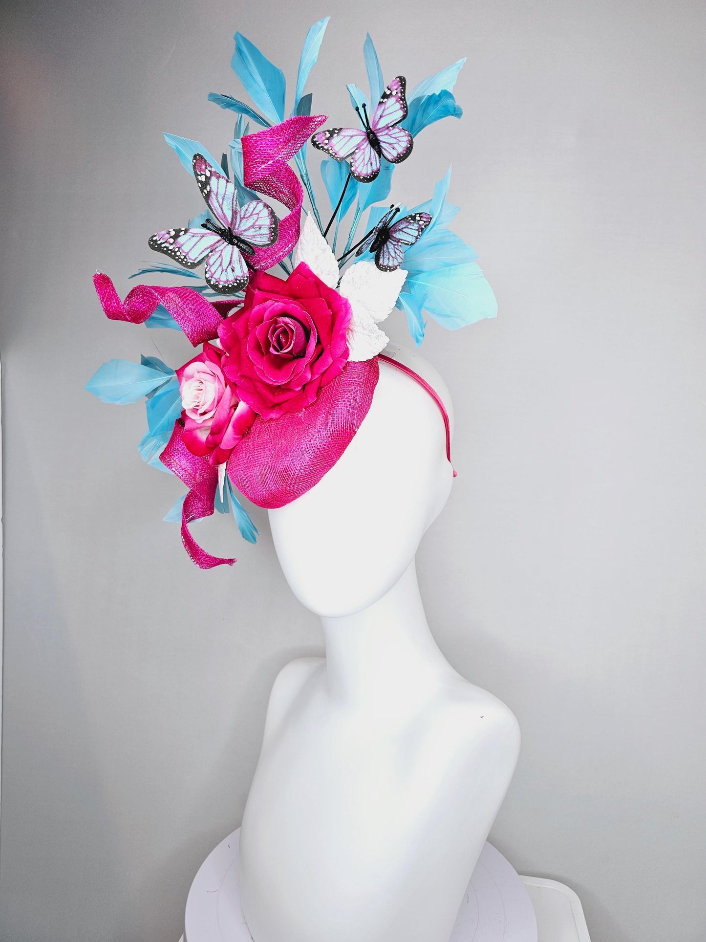 kentucky derby hat fascinator fuchsia pink sinamay with curls,ombre fuchsia pink satin roses,white leaves,sky blue feathers,blue butterflies