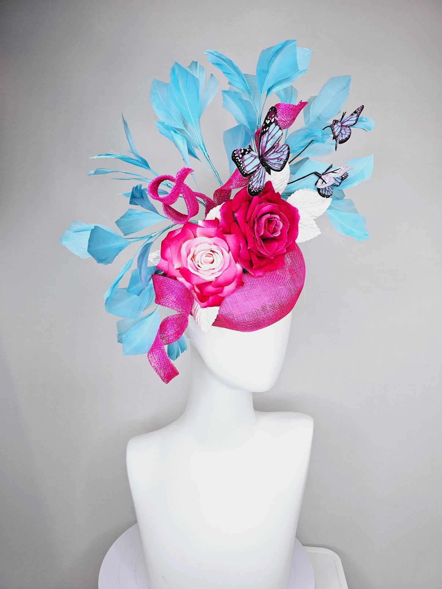 kentucky derby hat fascinator fuchsia pink sinamay with curls,ombre fuchsia pink satin roses,white leaves,sky blue feathers,blue butterflies