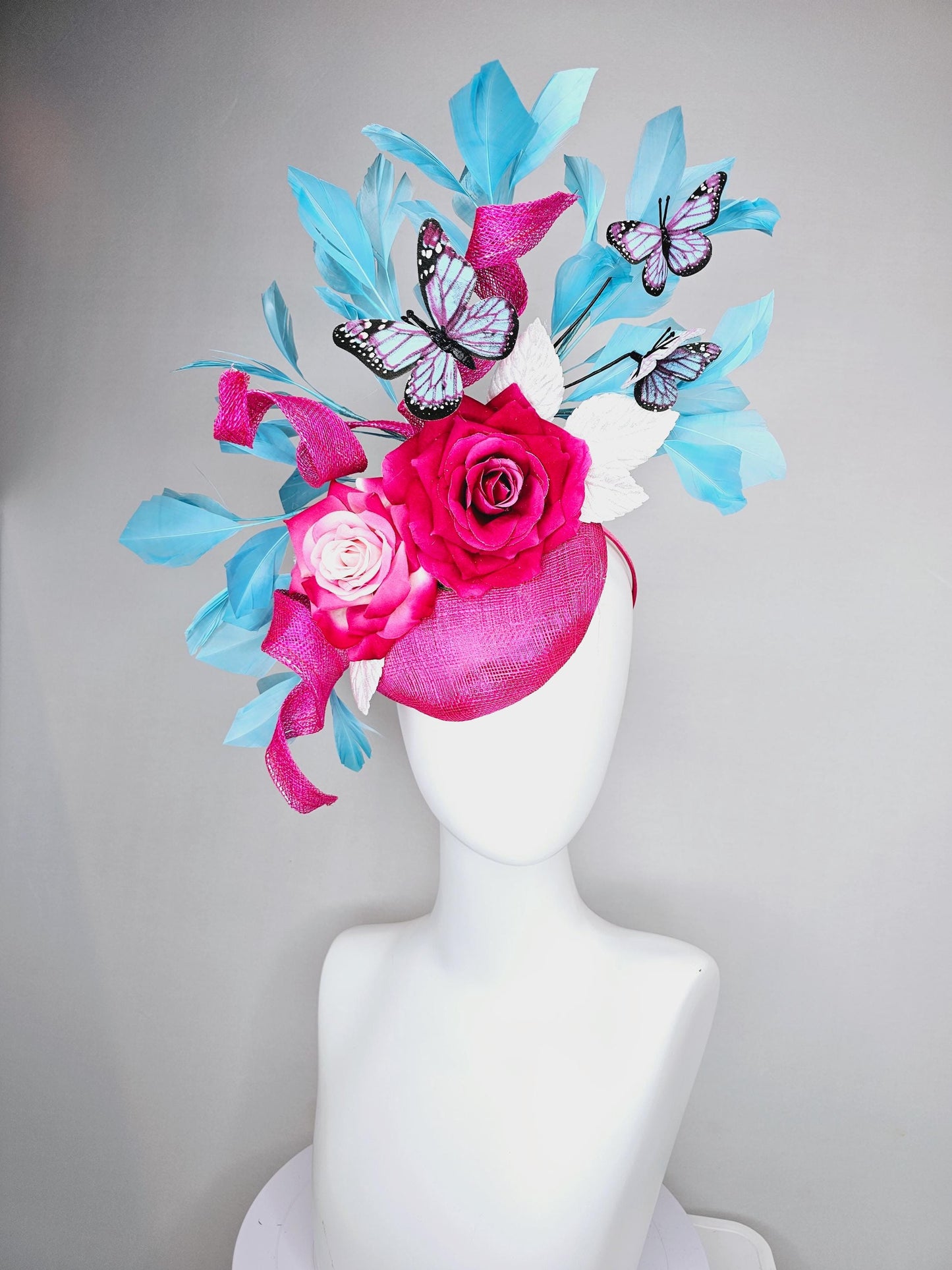 kentucky derby hat fascinator fuchsia pink sinamay with curls,ombre fuchsia pink satin roses,white leaves,sky blue feathers,blue butterflies