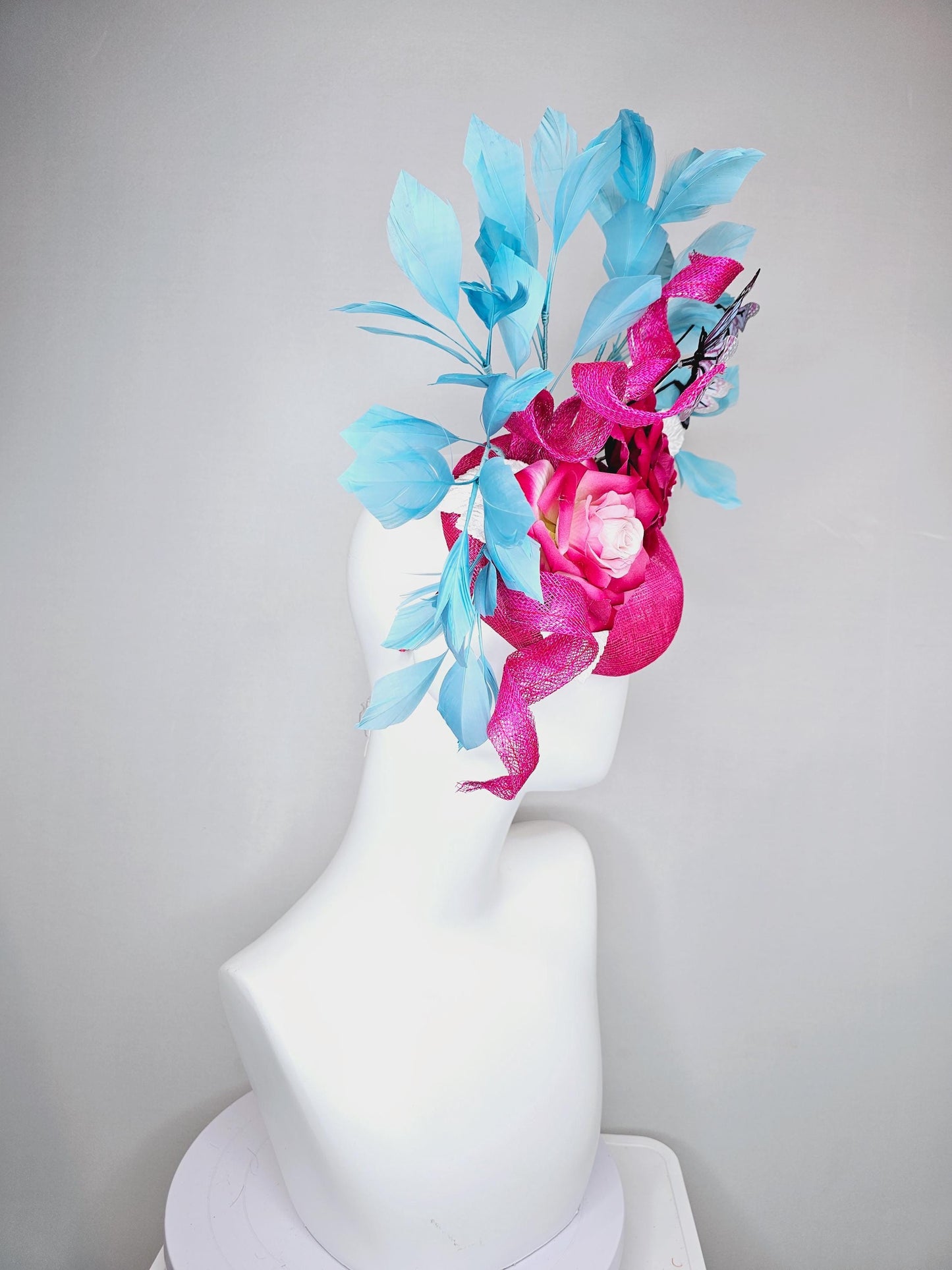 kentucky derby hat fascinator fuchsia pink sinamay with curls,ombre fuchsia pink satin roses,white leaves,sky blue feathers,blue butterflies