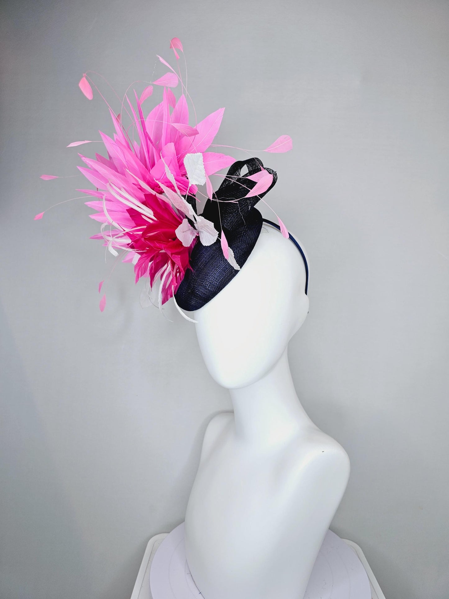 kentucky derby hat fascinator navy blue sinamay with hot pink feather flower, white velvet leaves and blush pink branching feathers