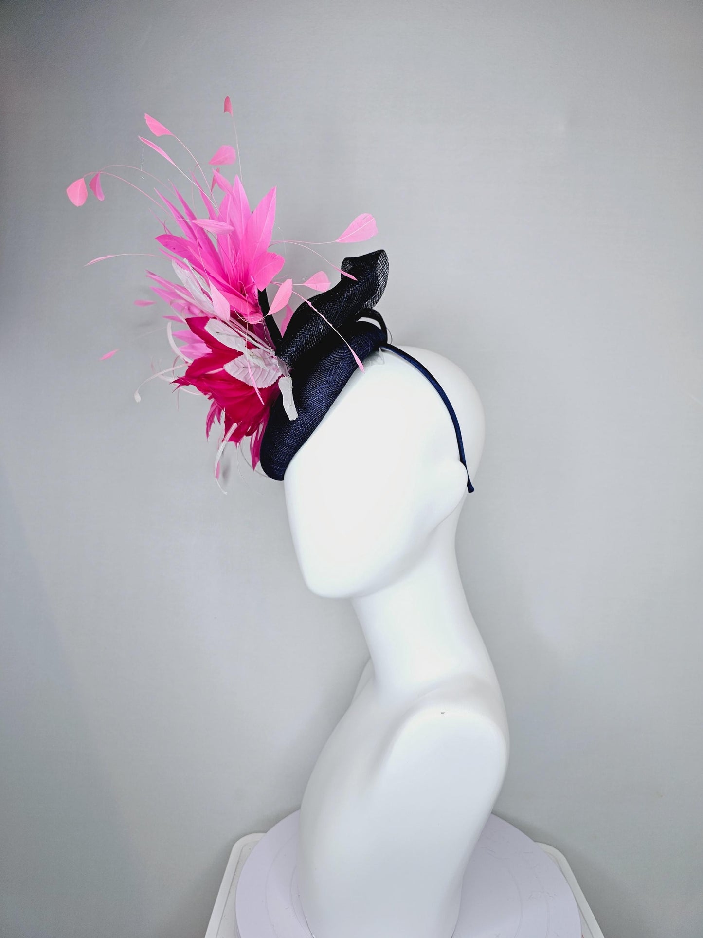 kentucky derby hat fascinator navy blue sinamay with hot pink feather flower, white velvet leaves and blush pink branching feathers